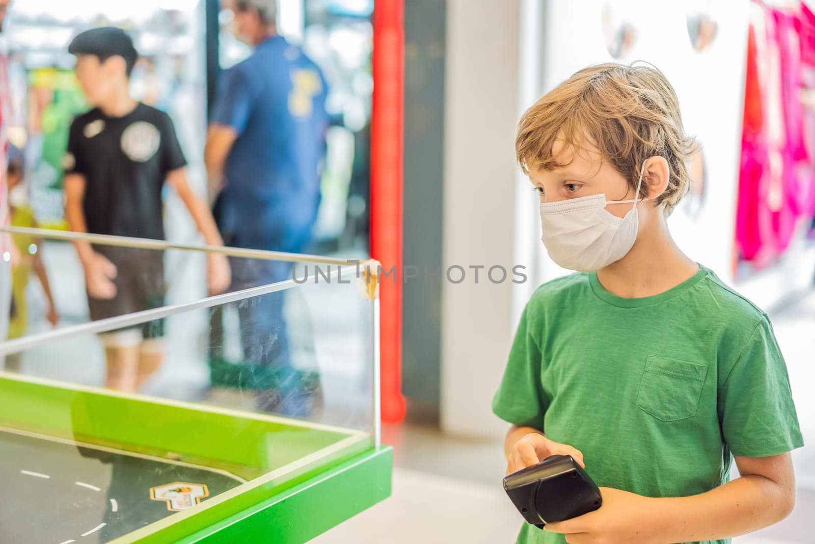Adorable cute little child playing with toy on remote control, in the mall. Happy kid boy having fun. Leisure, lifestyle for kids concept.