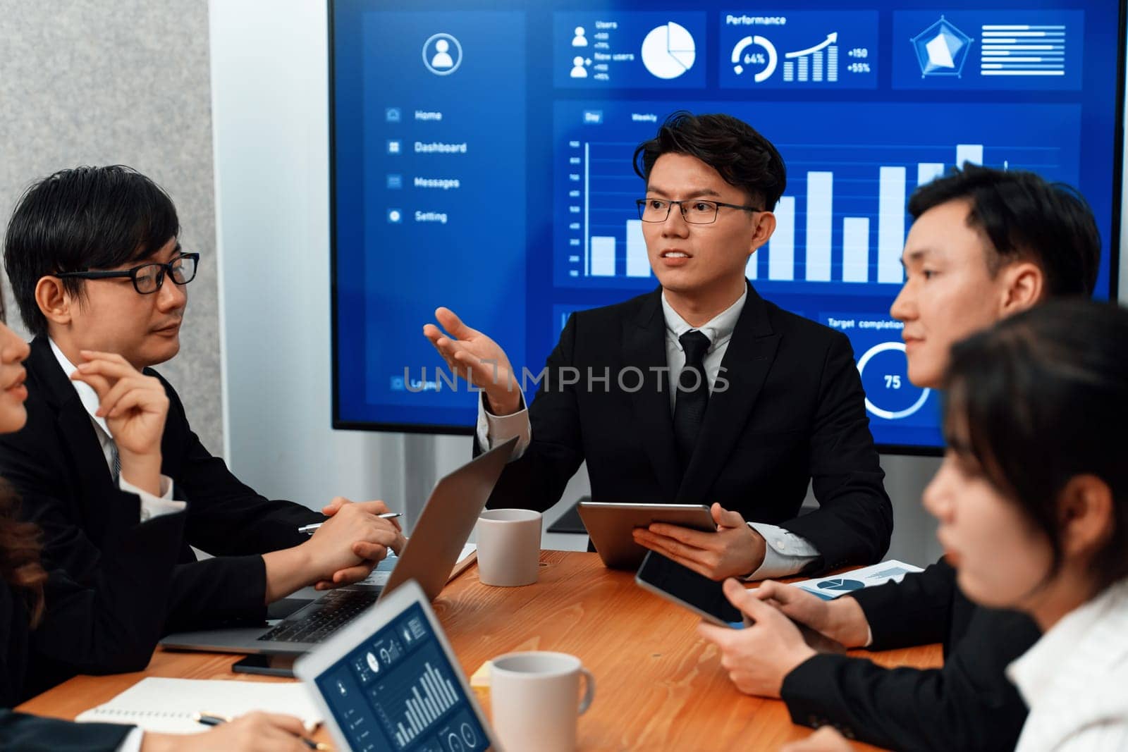Business team of financial data analysis meeting with business intelligence, report paper and dashboard on laptop for marketing strategy. Business people working together to promote harmony in office.
