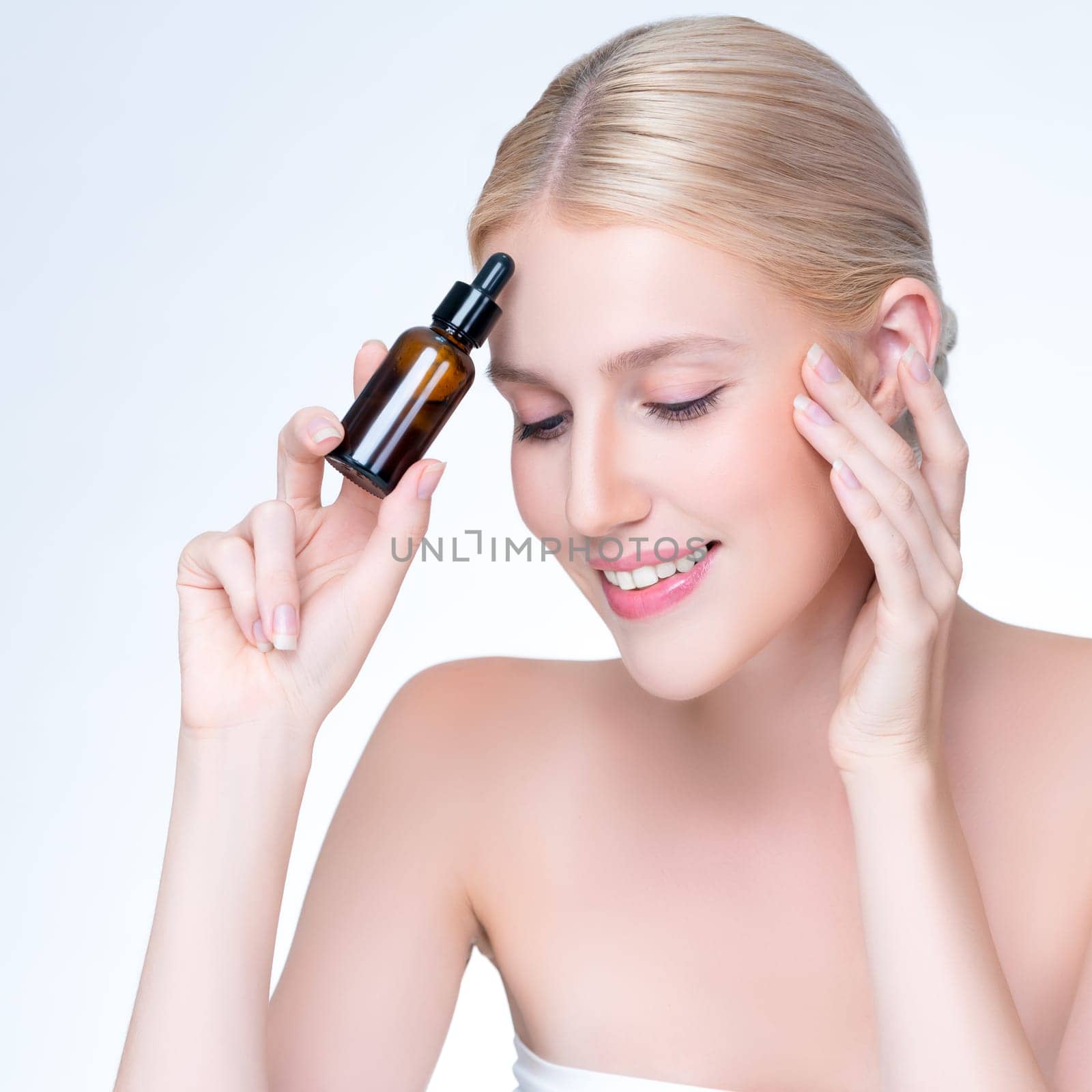 Closeup personable portrait of beautiful woman applying essential oil bottle for skincare product. Cannabis extracted CBD oil dropper for treatment and cannabinoids concept in isolated background.