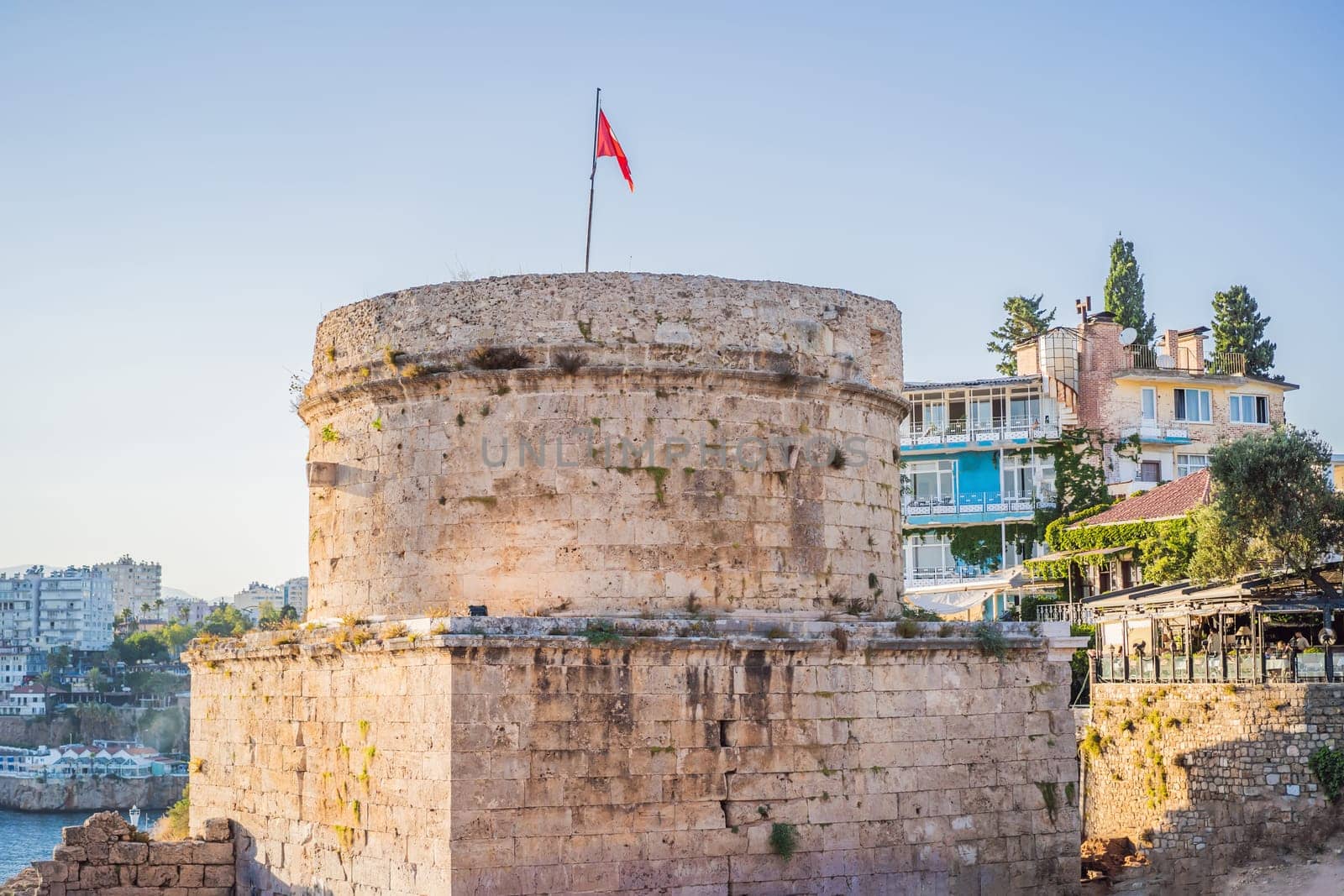 The Hidirlik Tower in Antalya against the backdrop of the Mediterranean bay of the ancient Kaleici district, Turkey. Turkiye by galitskaya