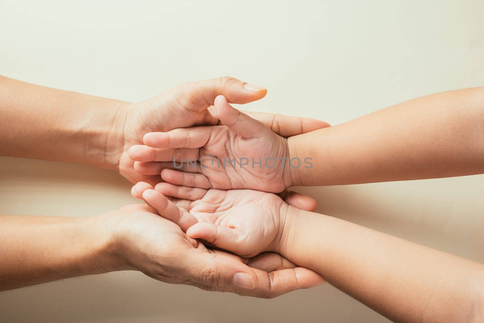 Top view parents and little kid holding empty hands together studio shot isolated on pastel background, family home, hands children on adult mother hand, help support, parents family day concept