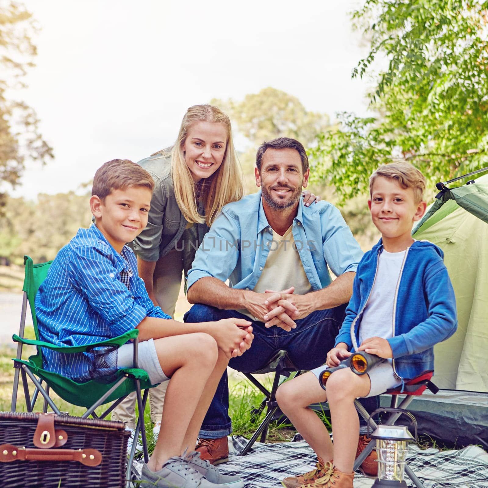 We love camping. Cropped portrait of a family of four camping in the woods