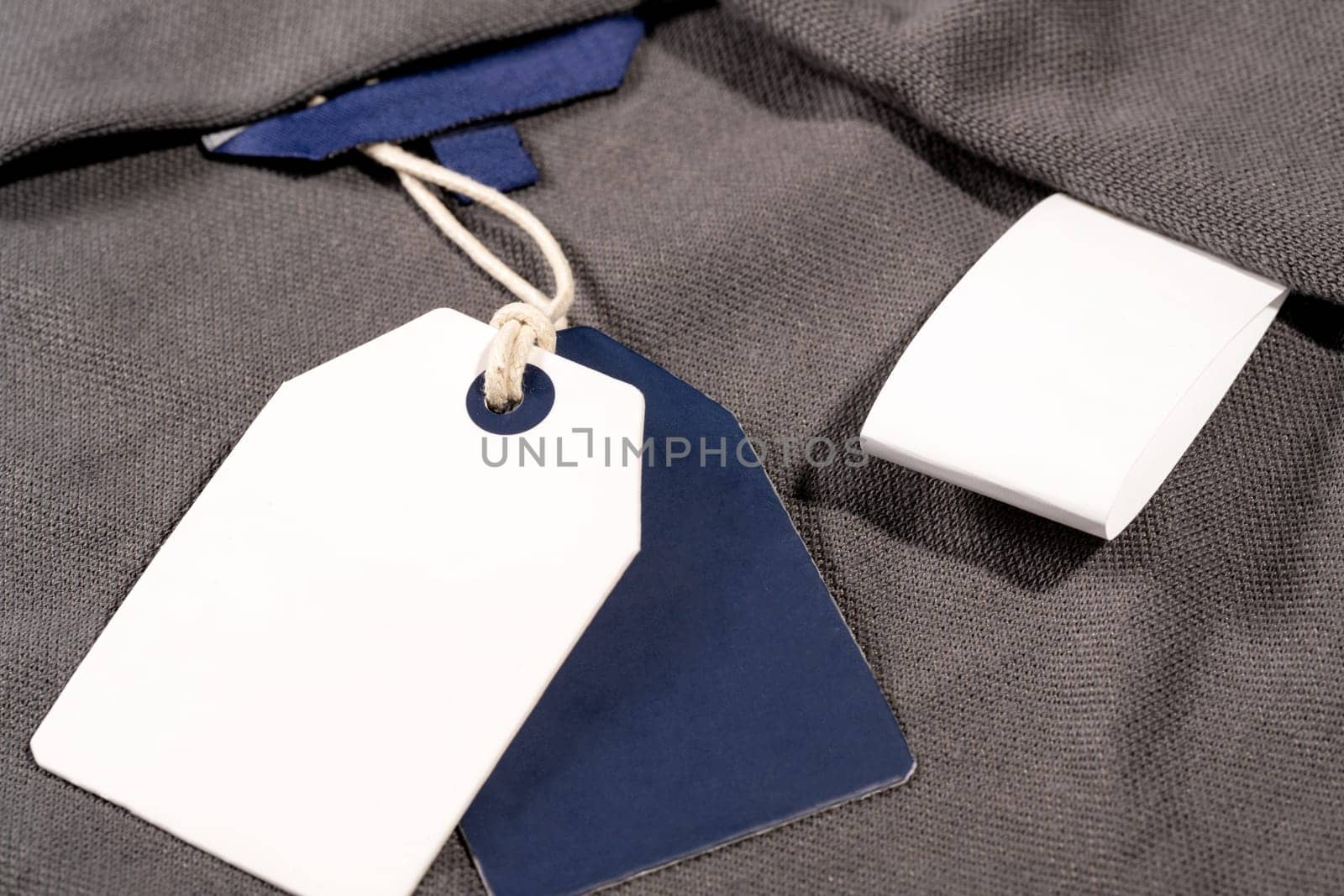 A closeup shot of white blue clothing tags on a string with copy space and a blank tag