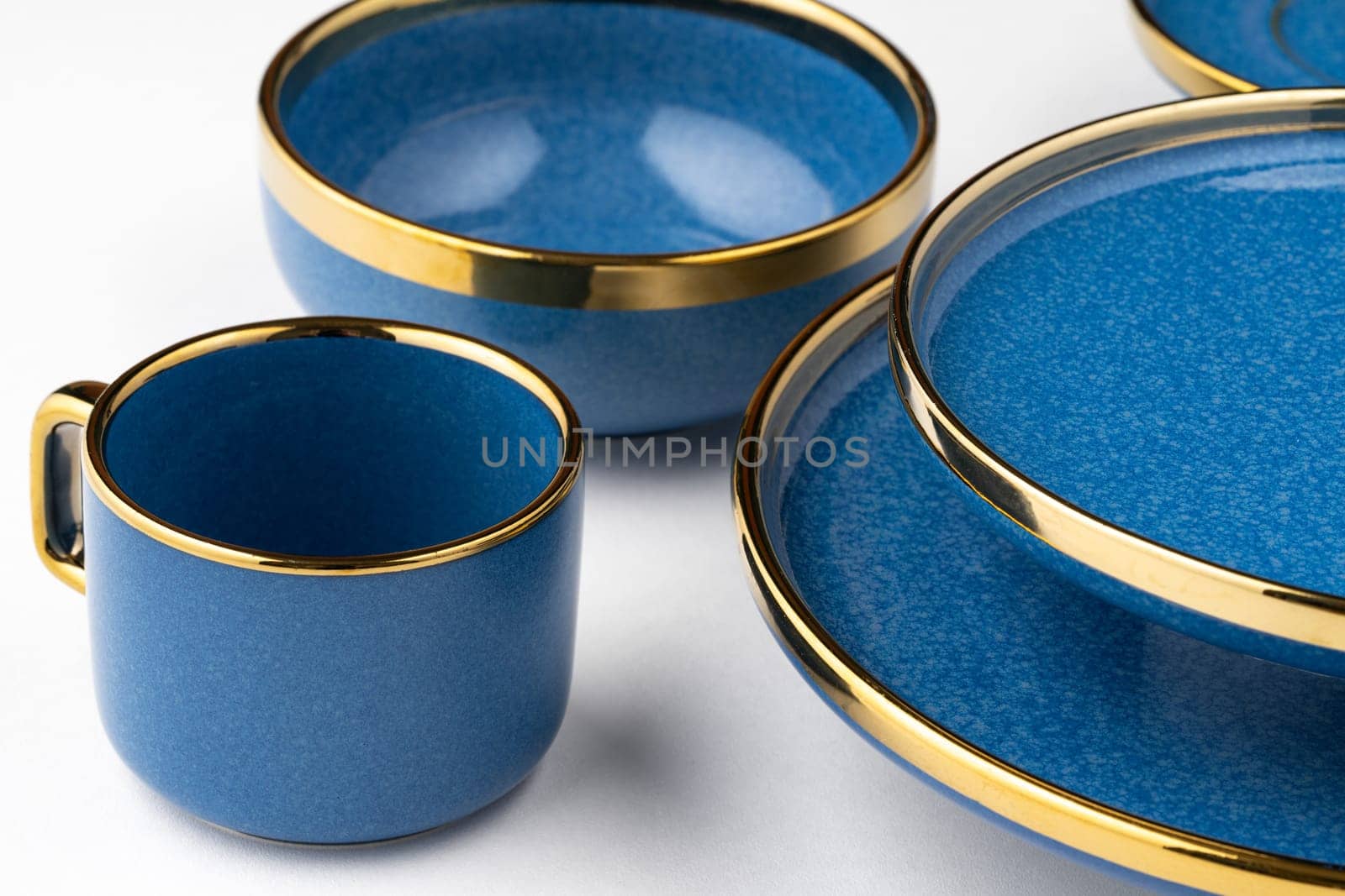 A set of blue ceramic plates and cup on a white background by A_Karim