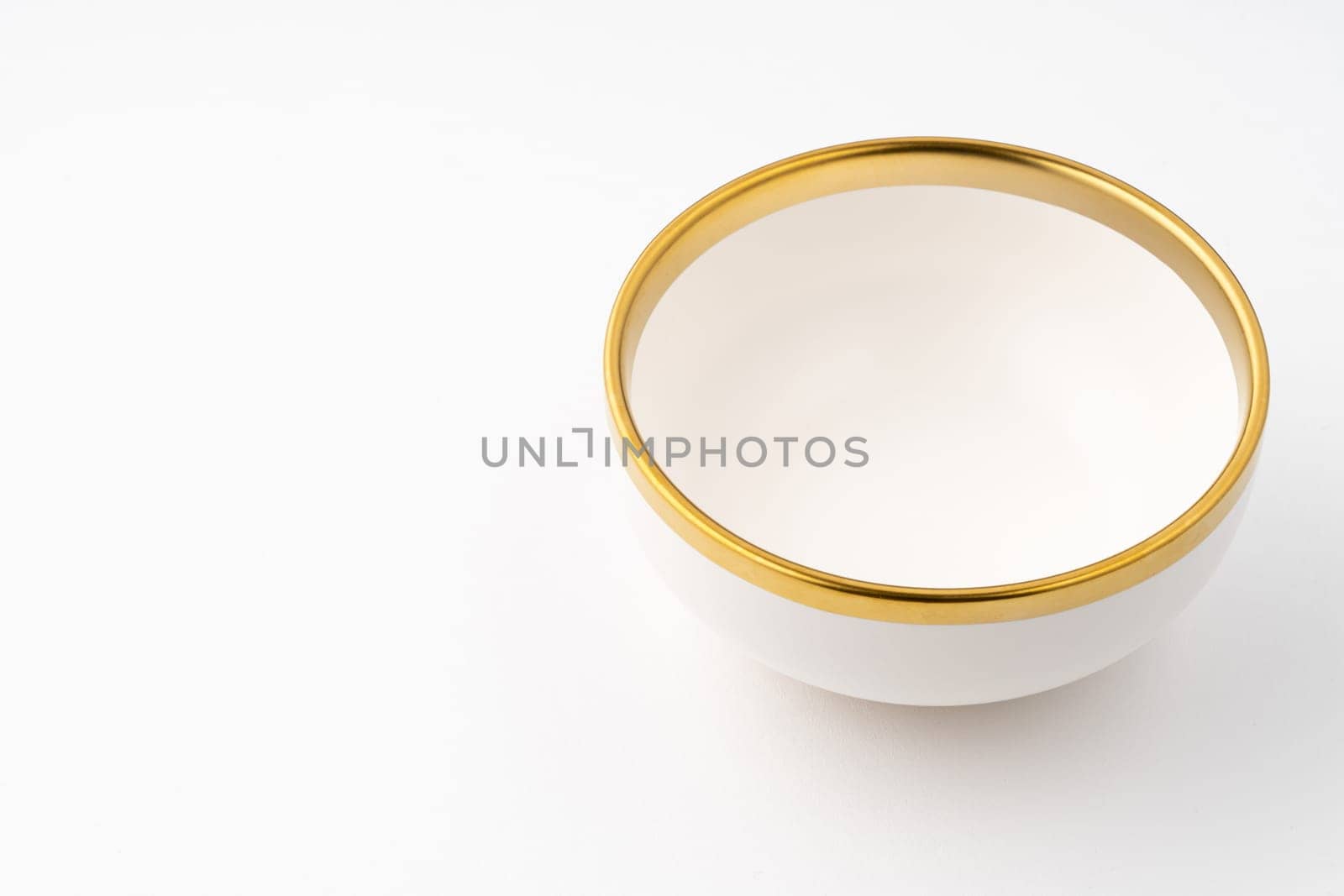 A white and brown ceramic bowl on a white background