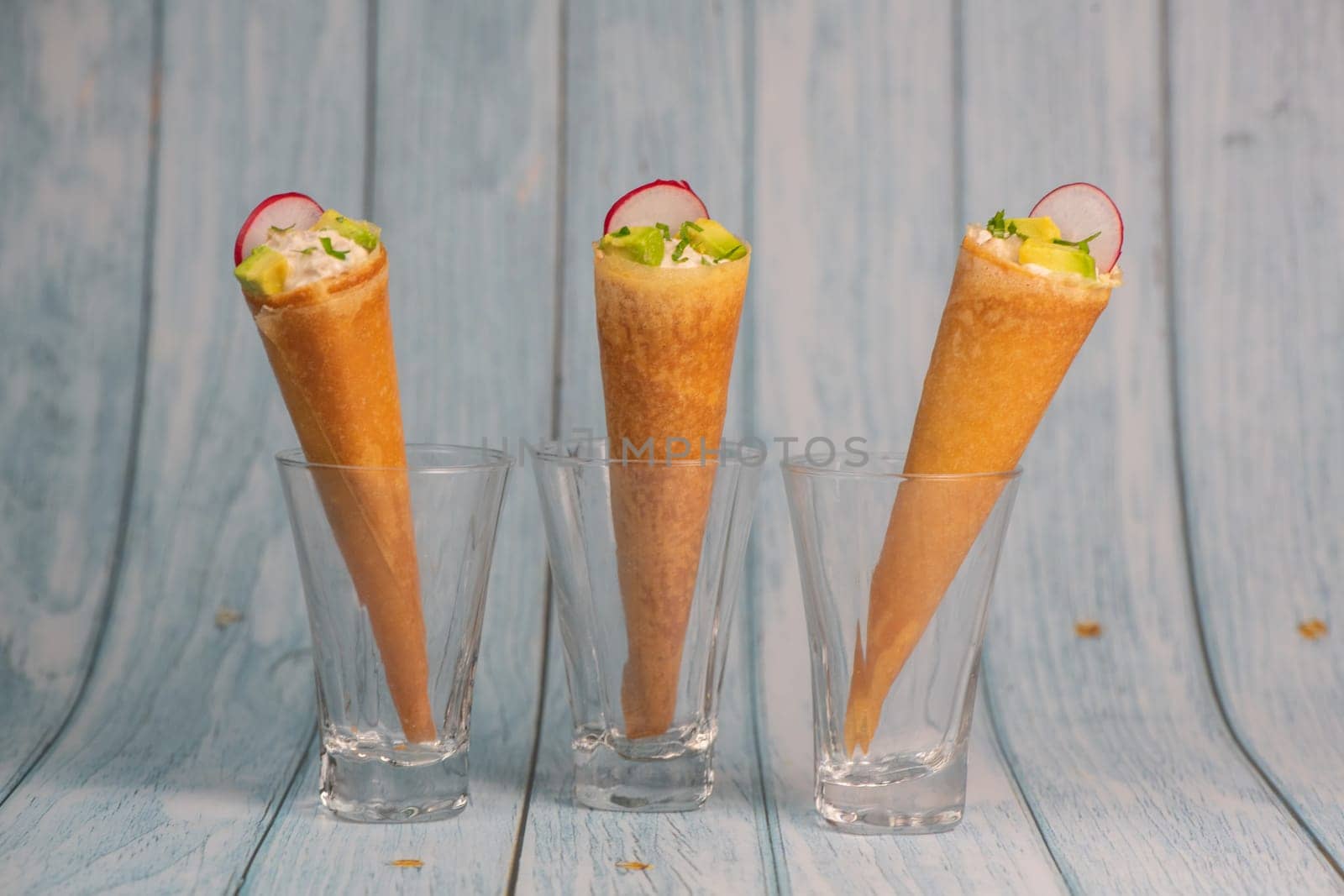 Brick cone with tuna sauce, mayonnaise, avocado and radish slice, High quality photo
