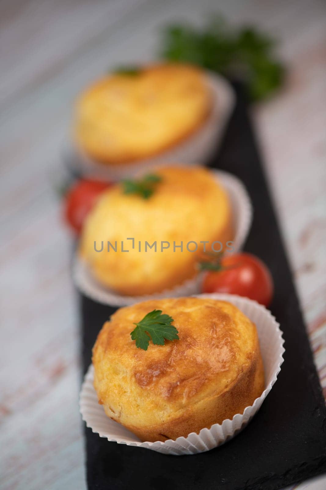 Savory muffin with ham and cheese on blue background, High quality photo