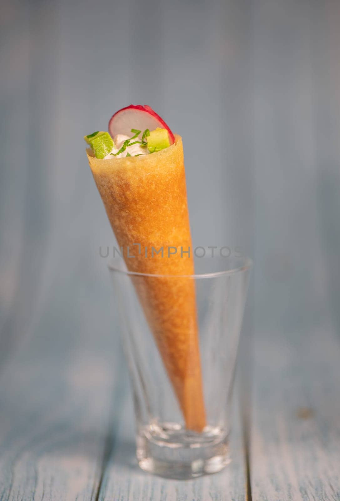 Brick cone with tuna sauce, mayonnaise, avocado and radish slice, High quality photo
