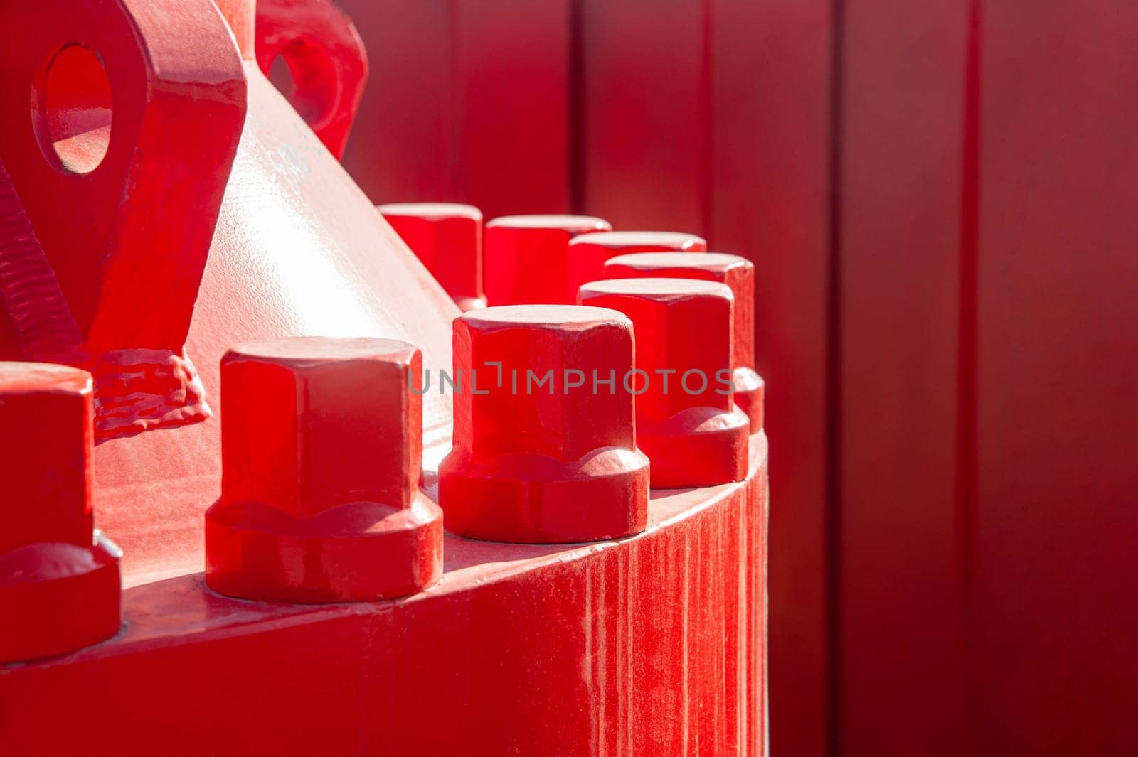 A closeup of a red industrial oil pipeline valves