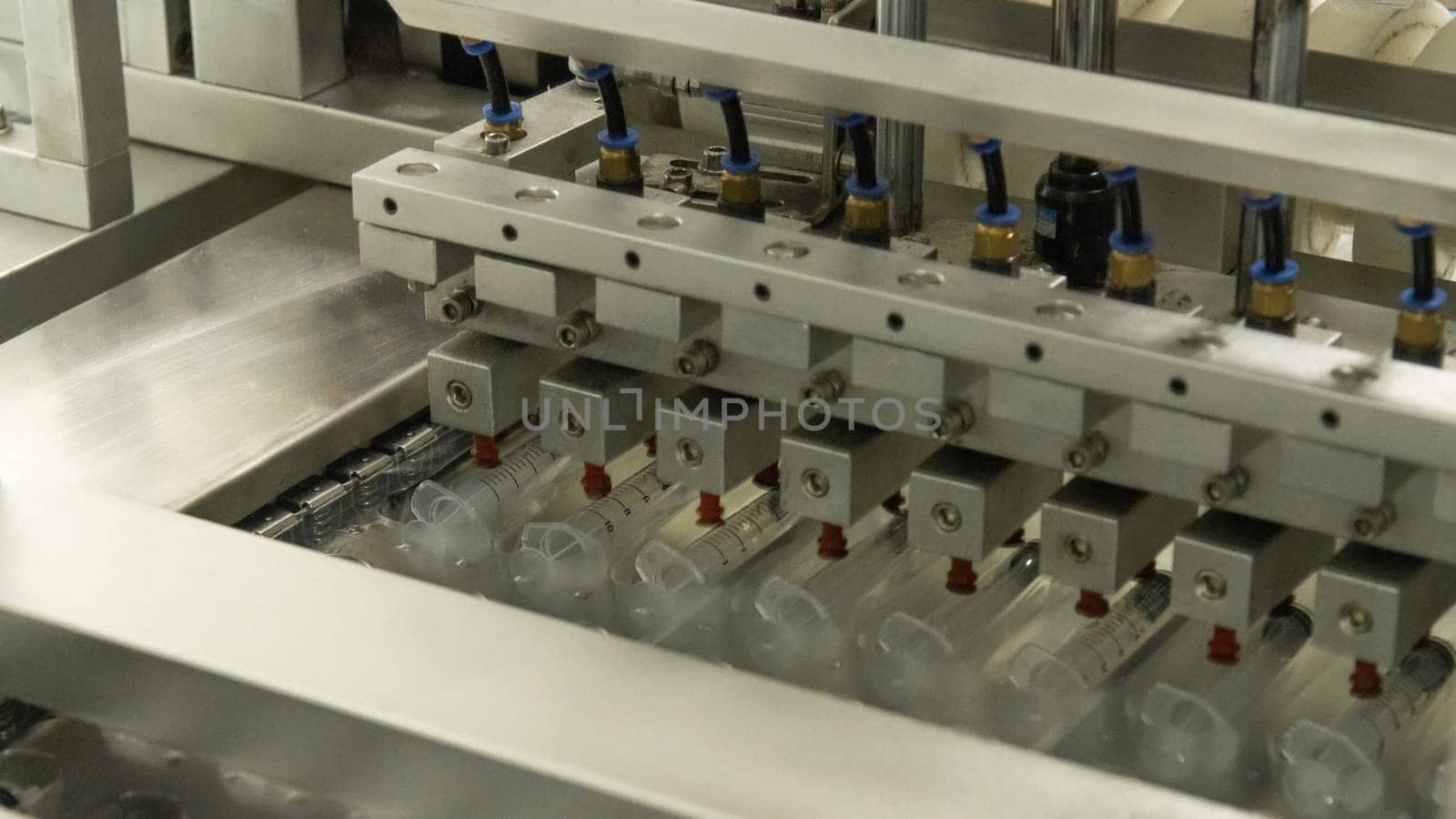 A closeup of the production of medical syringes by A_Karim