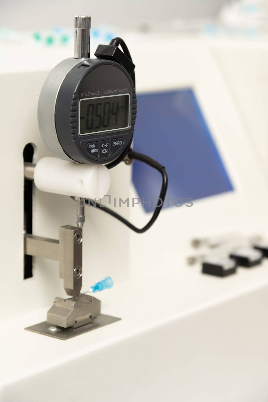 A vertical closeup shot of equipment in a medical laboratory for manufacturing medical syringes