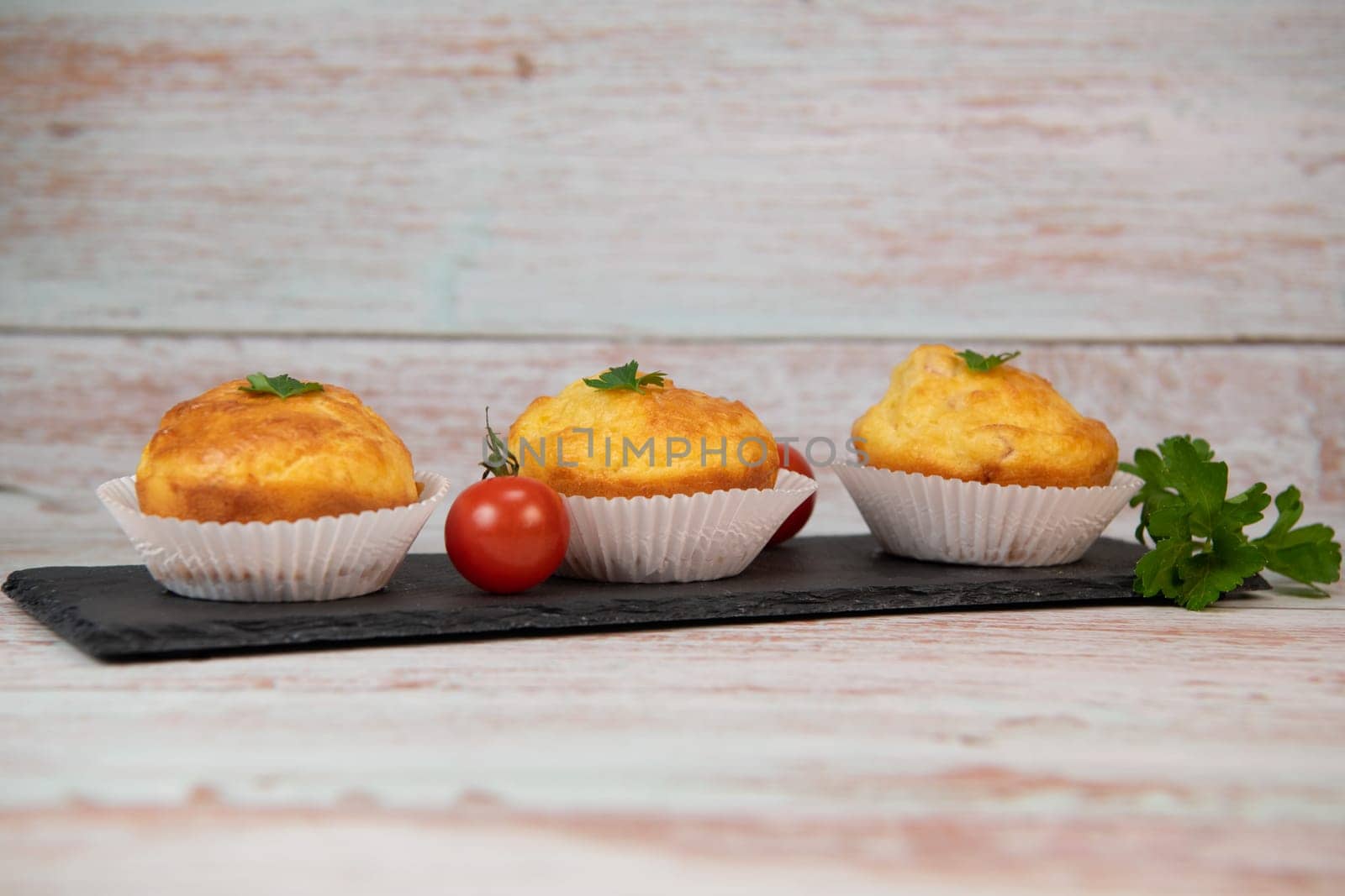 Savory muffin with ham and cheese on blue background, High quality photo
