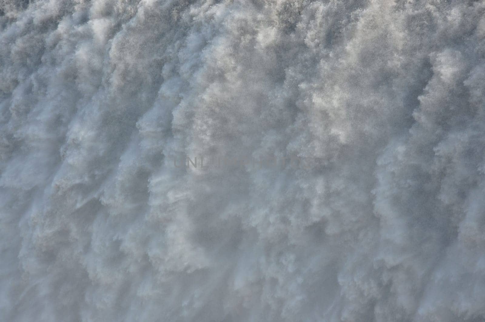Closeup of a massive, foamy waterfall in Iceland