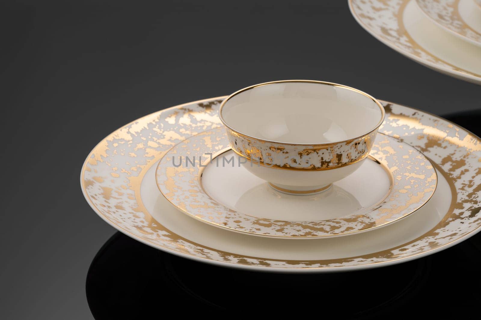 A luxury tableware set on black reflective surface