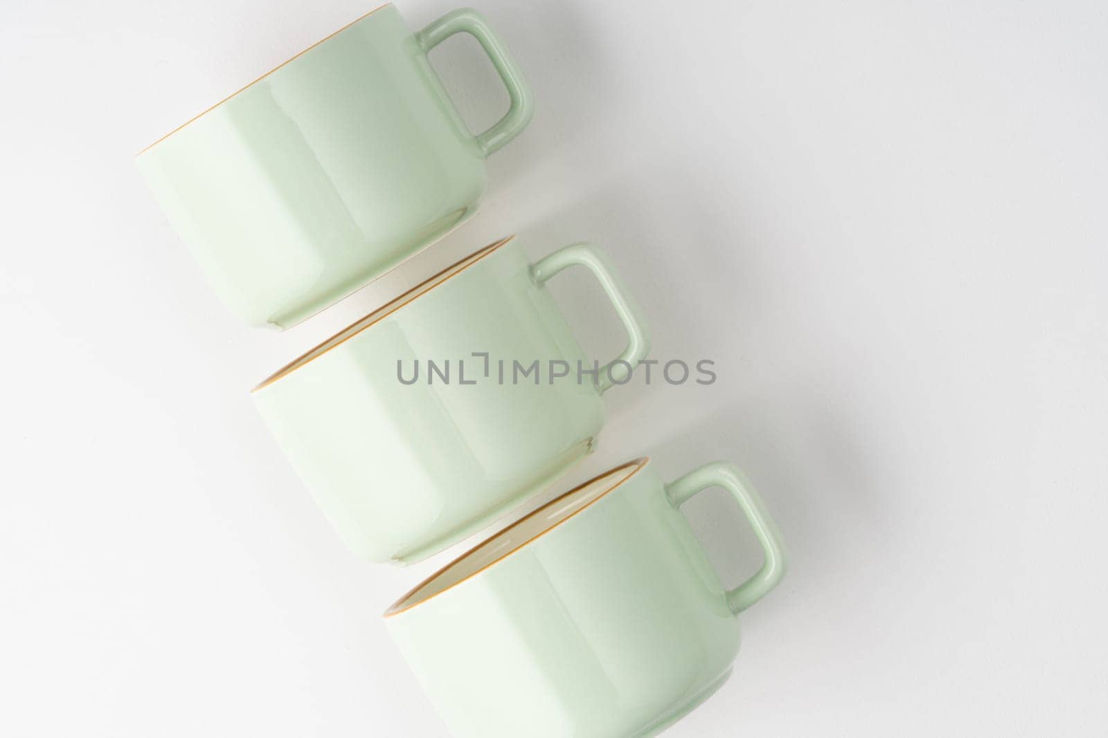 A set of white and pastel green ceramic teacups with orange outlines by A_Karim