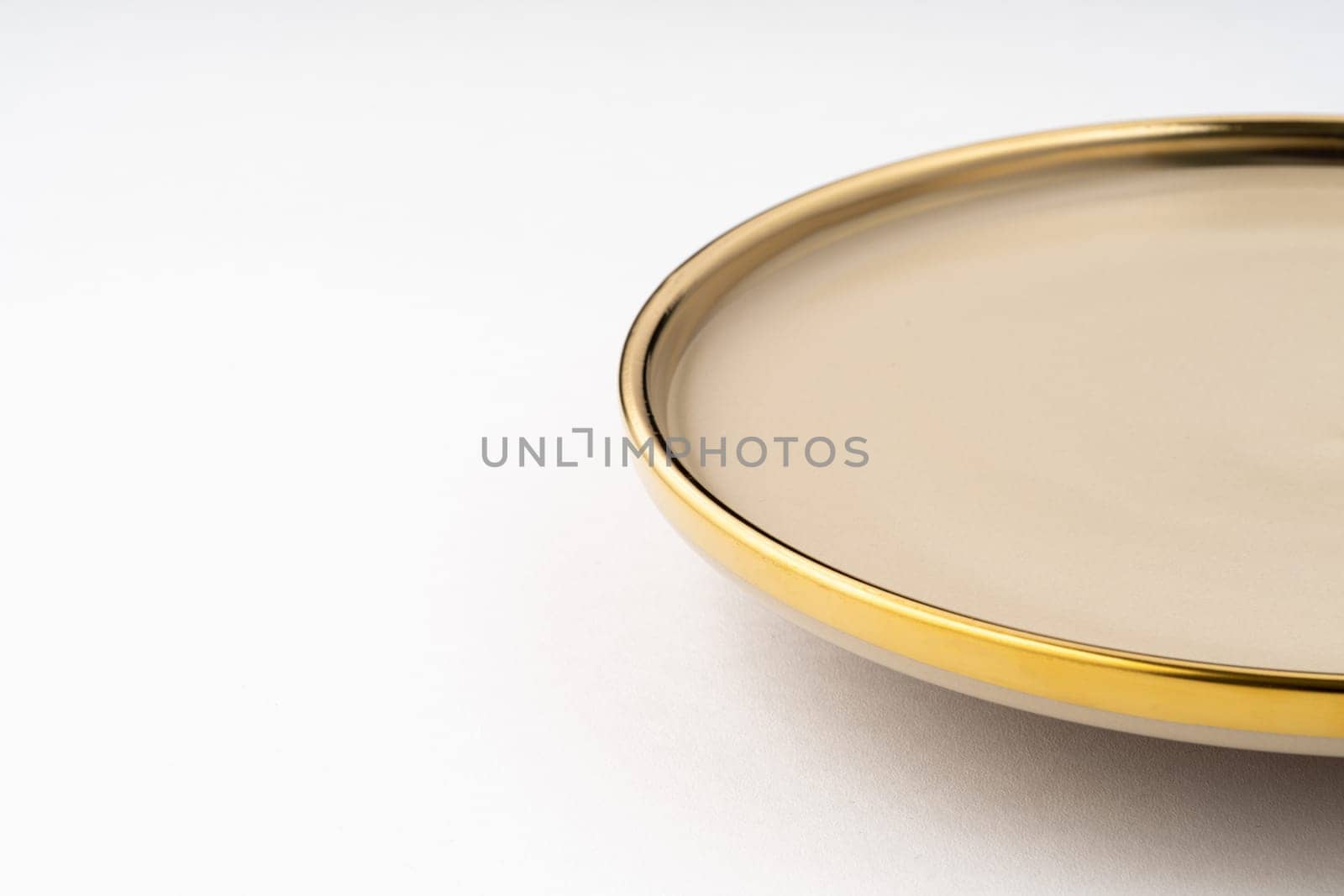 A light brown ceramic plate on a white background. Close-up