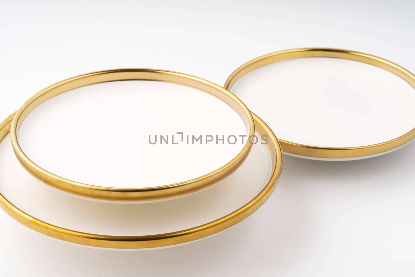 A set of white and brown ceramic plates on a white background