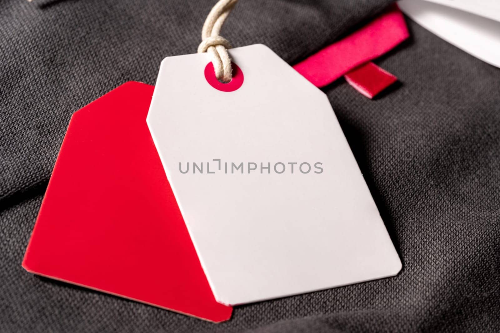 A closeup shot of white red clothing tags on a string with copy space by A_Karim