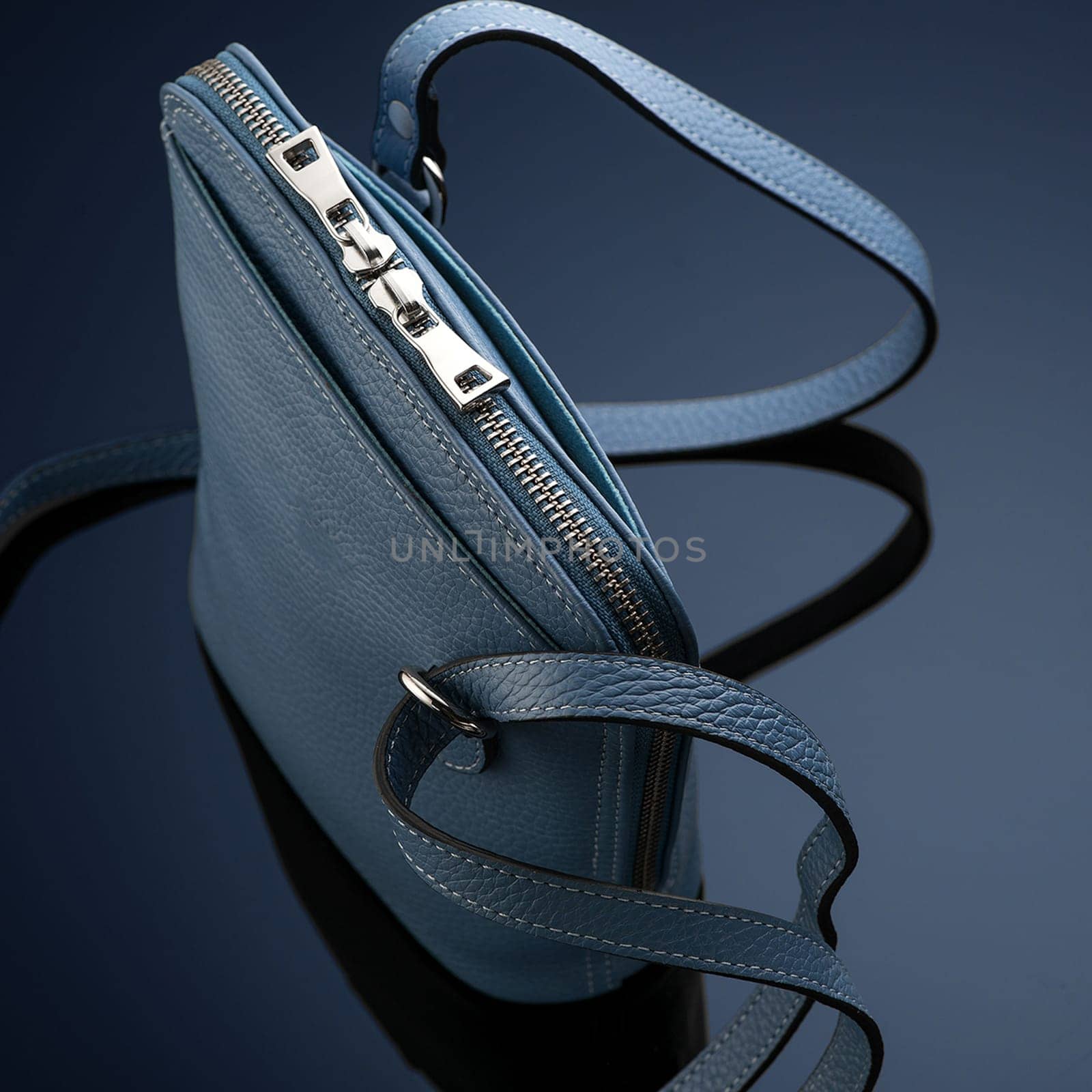A closeup shot of a luxury blue leather bag by A_Karim