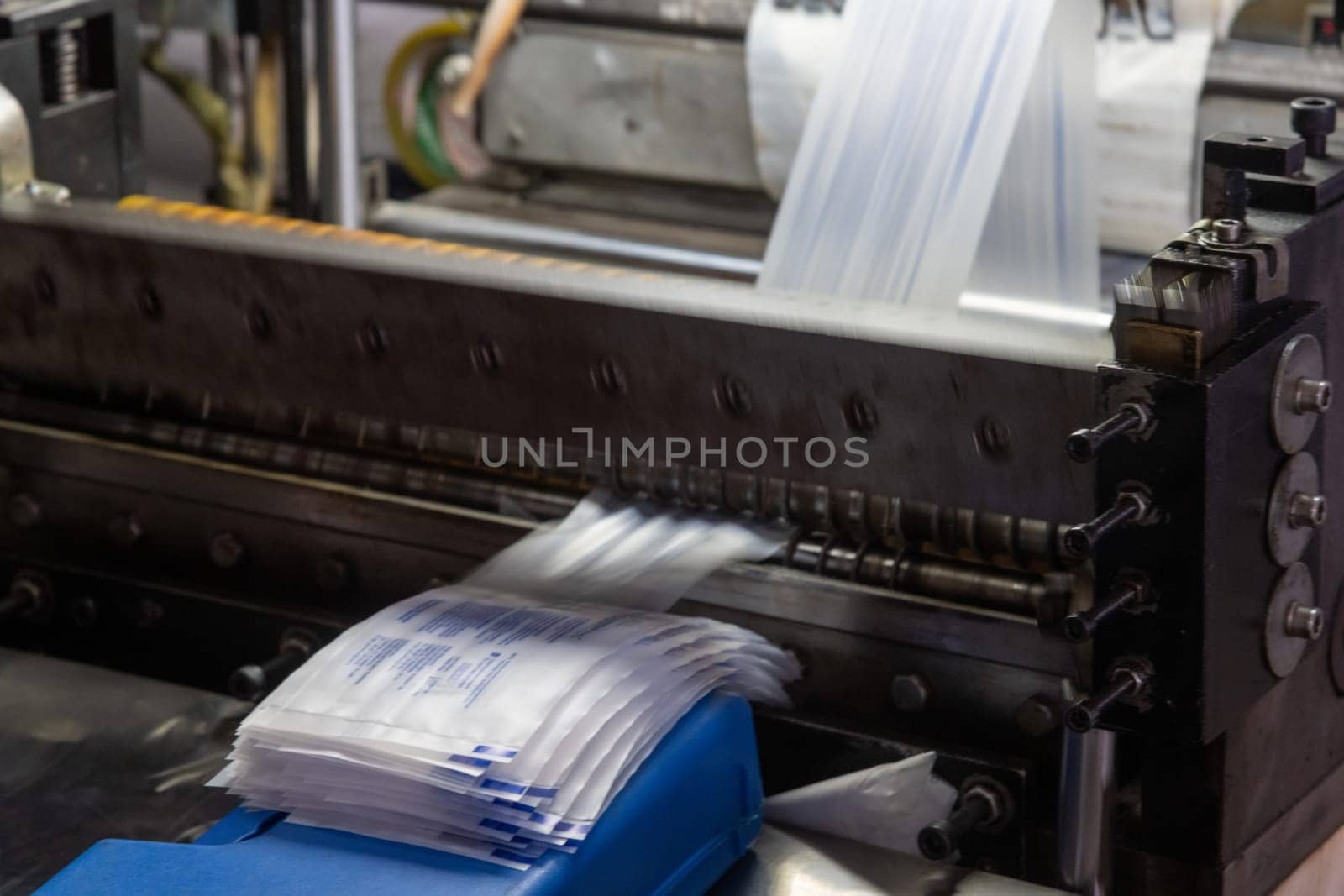 A closeup shot of a machine printing syringe labels at a medical production warehouse