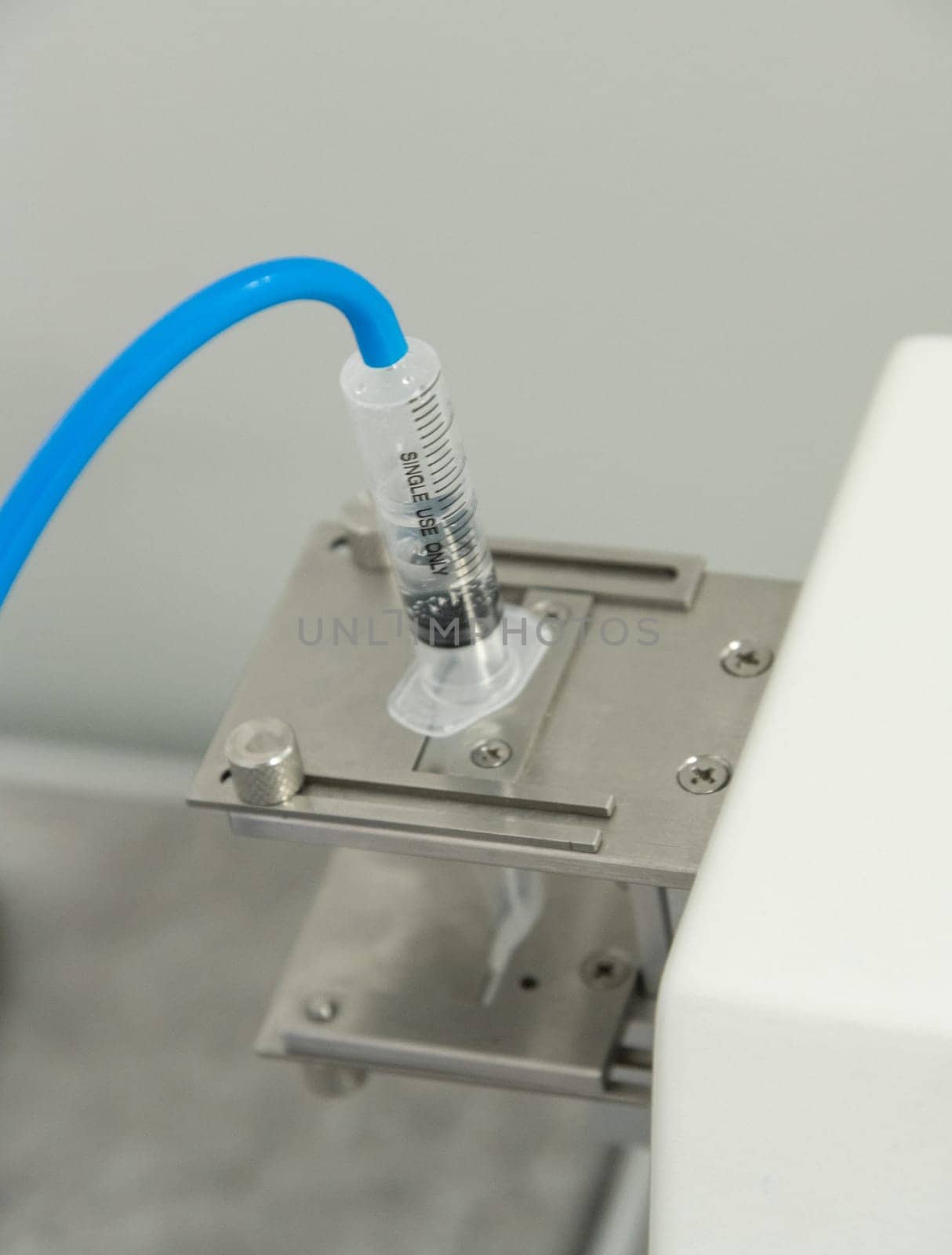 A closeup of the production and testing of medical syringes and droppers by A_Karim