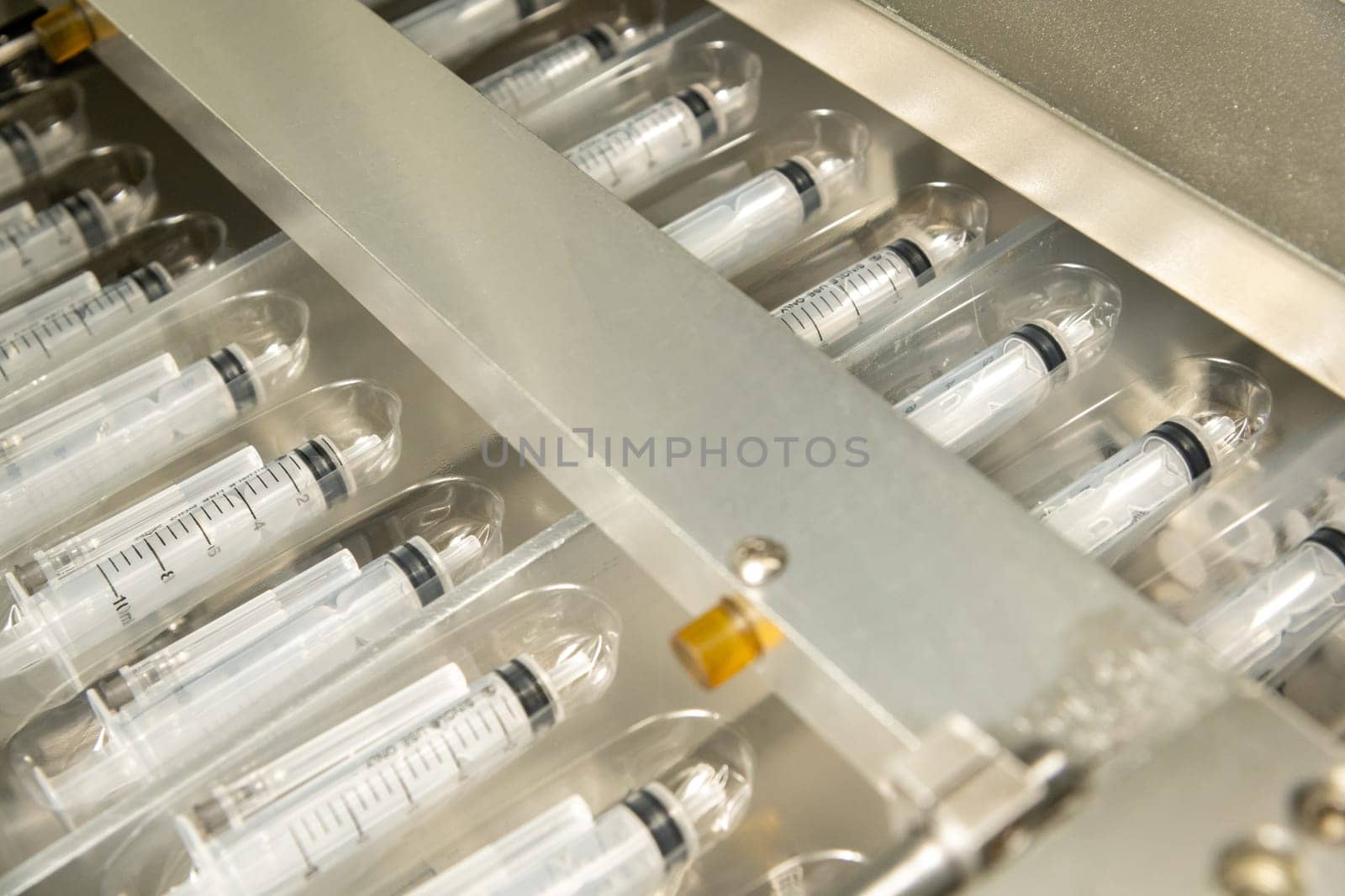 A closeup of the production of medical syringes by A_Karim