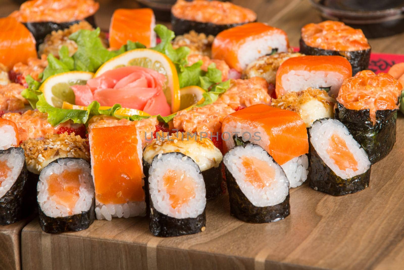 A closeup shot of a sushi set on a wooden plate