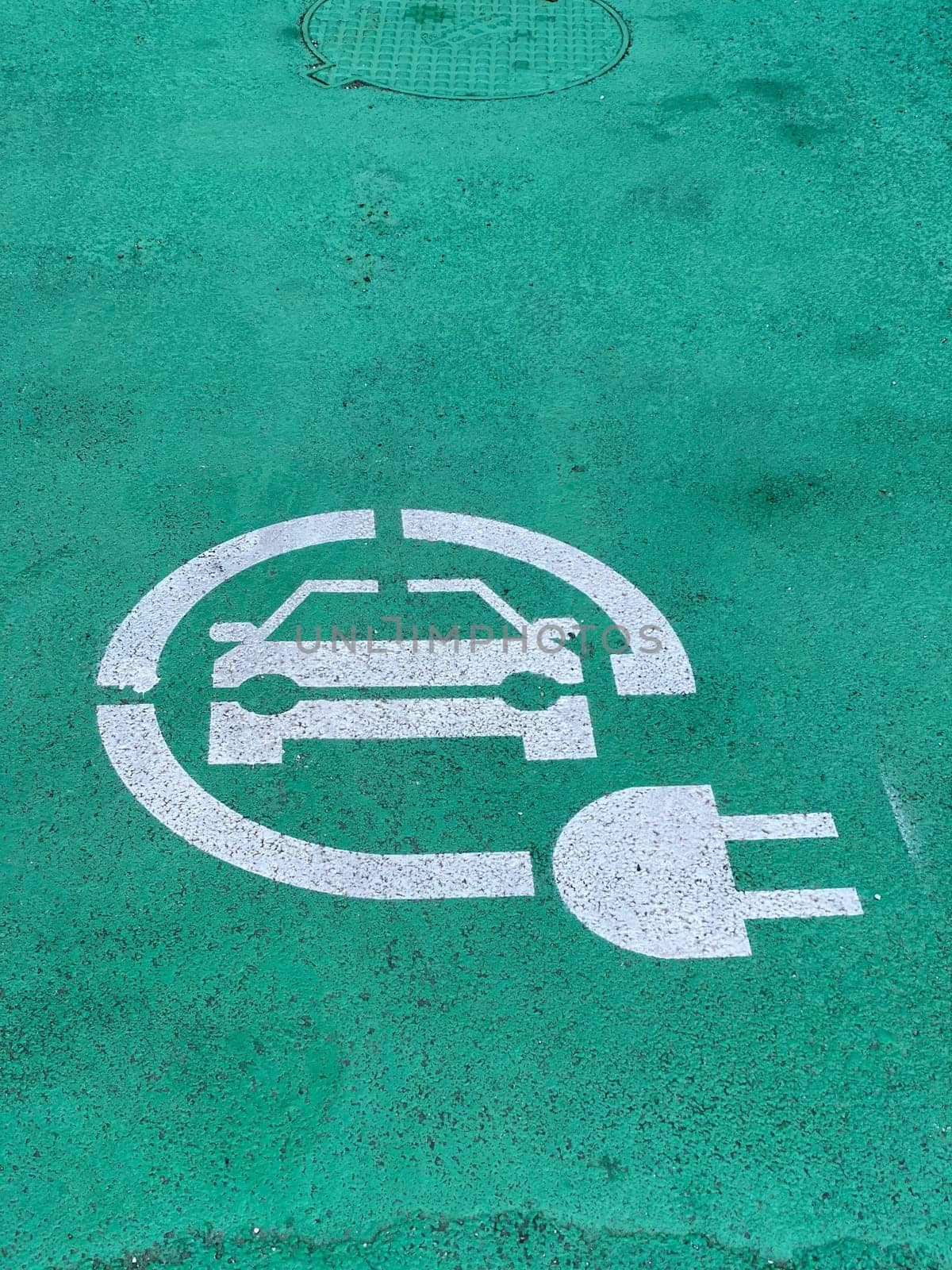 Charging station for electric cars near the walls of Basilica, green sign by verbano