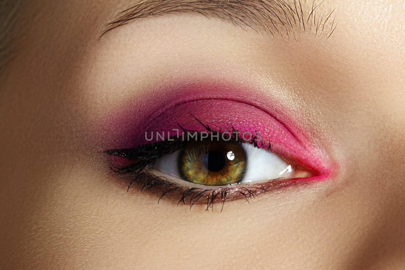 Closeup Macro of Woman Face with Green Eyes Make-up. Fashion Pink Celebrate Makeup, Glowy Clean Skin, perfect Shapes of Brows. Shiny Simmer