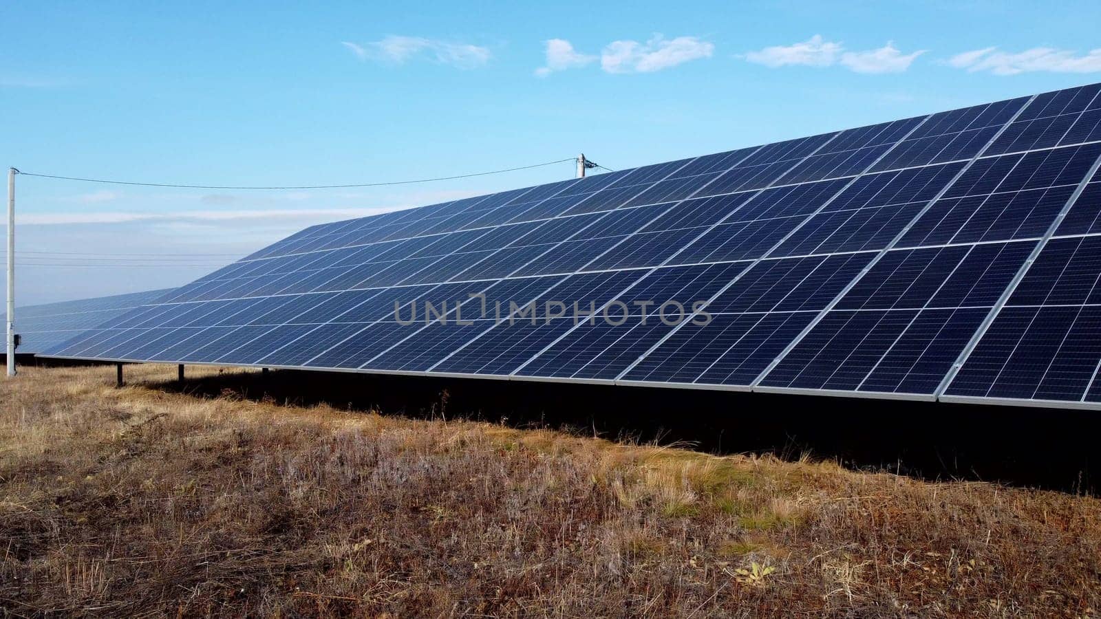 Solar power plant. Flight over modules of solar power station on sunny day. Alternative green electricity power. New modern technology. Renewable electrical energy. photovoltaic modules photobatteries