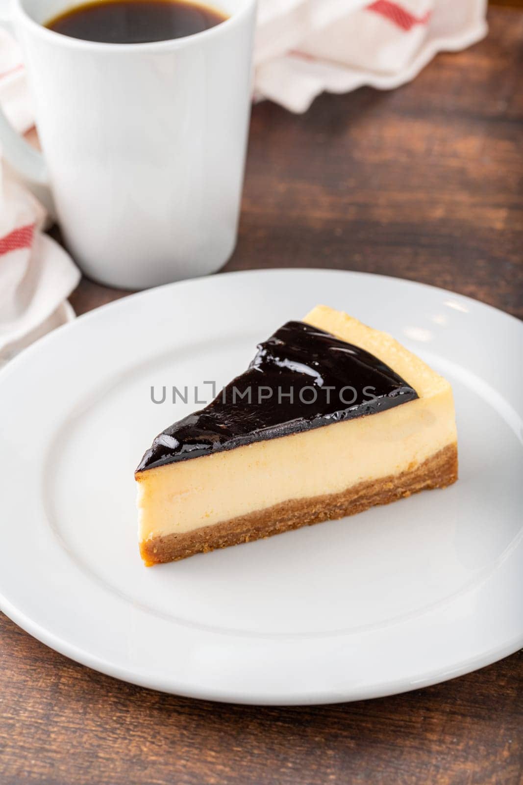 Chocolate cheesecake with brewing coffee on wooden table