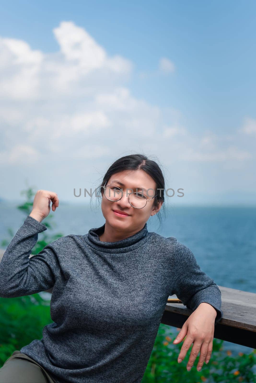Woman (LGBTQ) posing at sea viewpoint with happy by NongEngEng