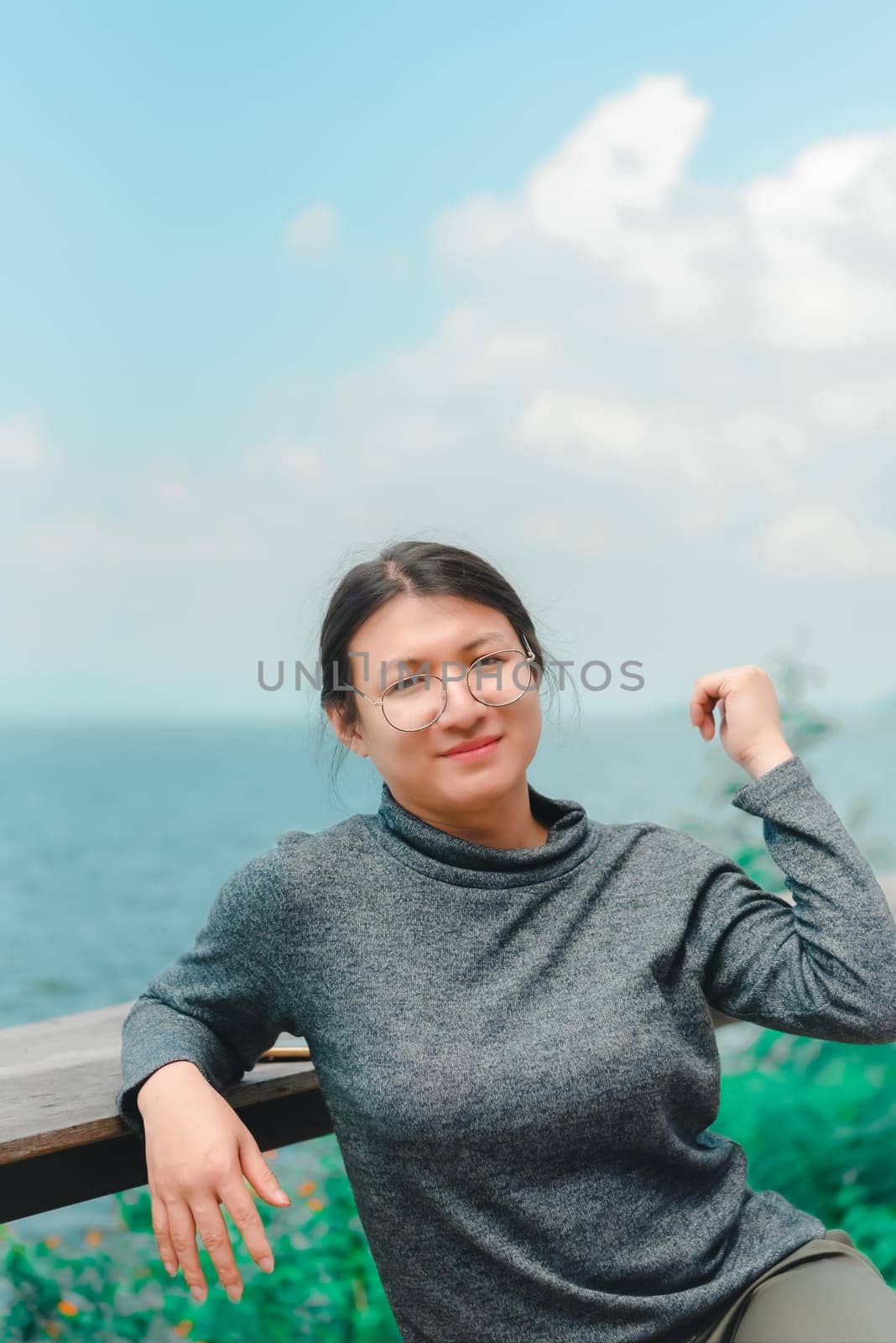Woman (LGBTQ) posing at sea viewpoint with happy by NongEngEng