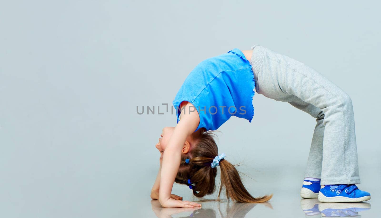 Little girl doing gymnastics exercise