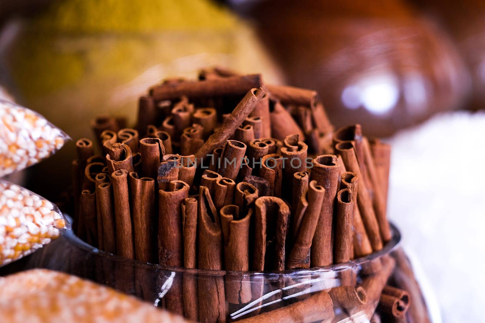 Cinnamon sticks in glass vase selling on market