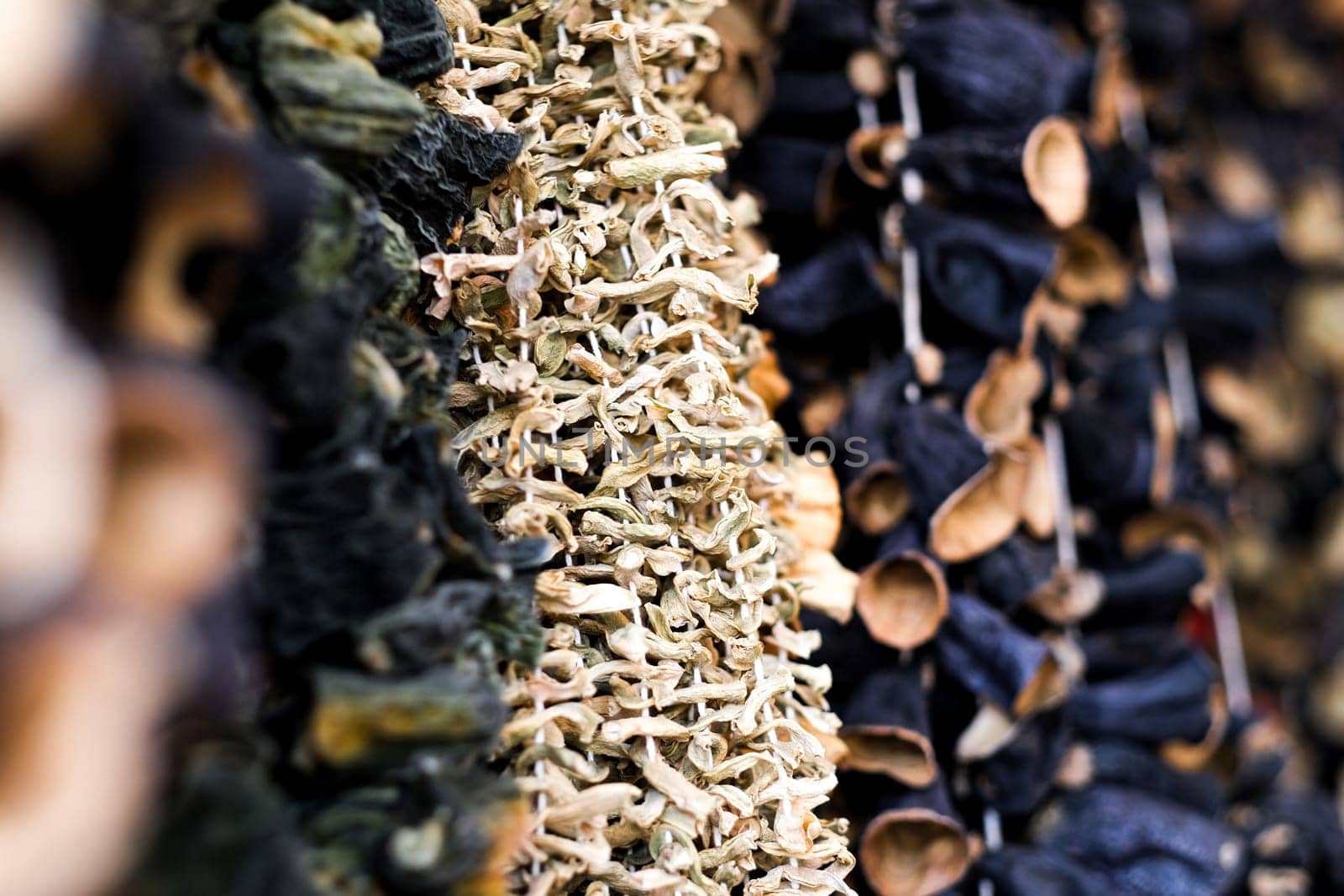 Dried eggplants hanging on threads for sell, selective focus