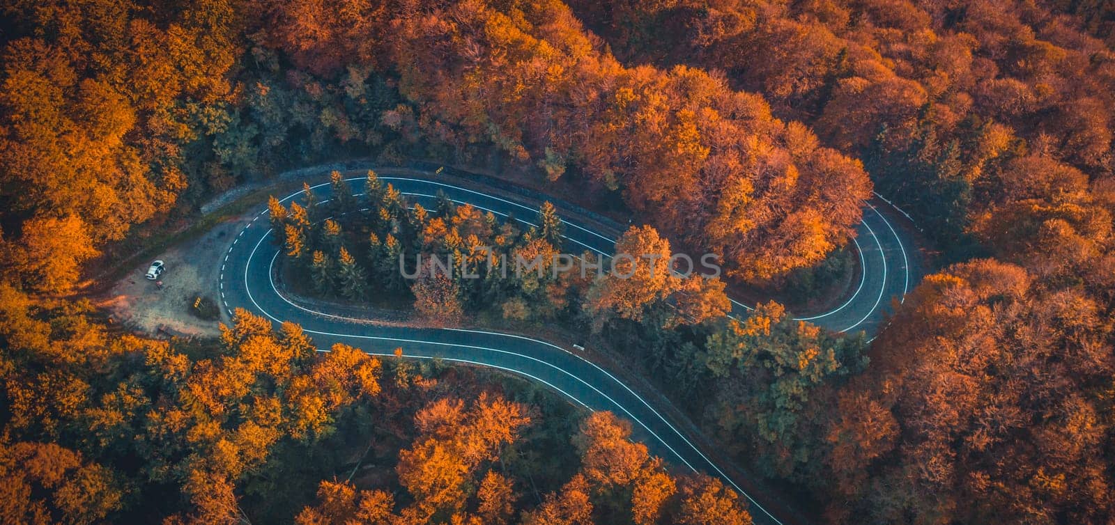 Transfagarasan serpentine going through autumn forest