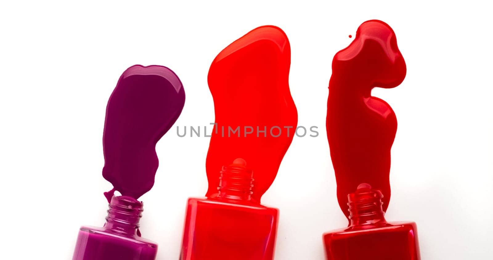 Bright colours of nail polish leaking from bottles