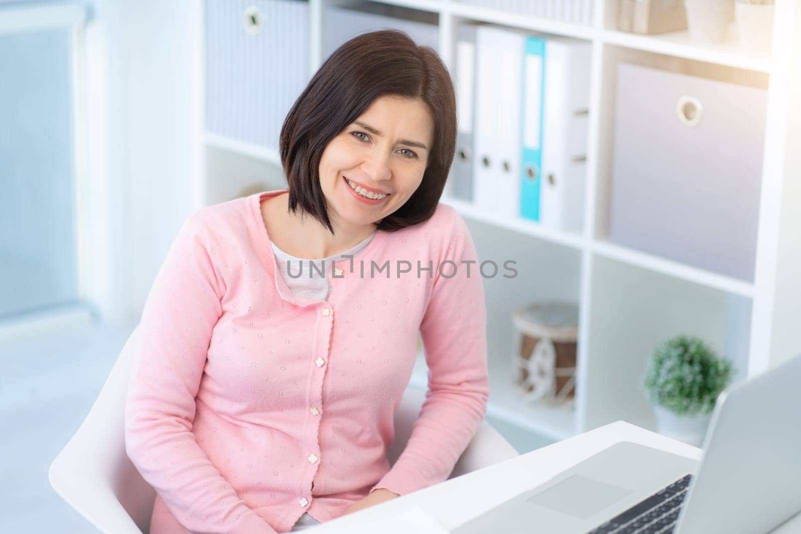 Happy woman at work in modern office