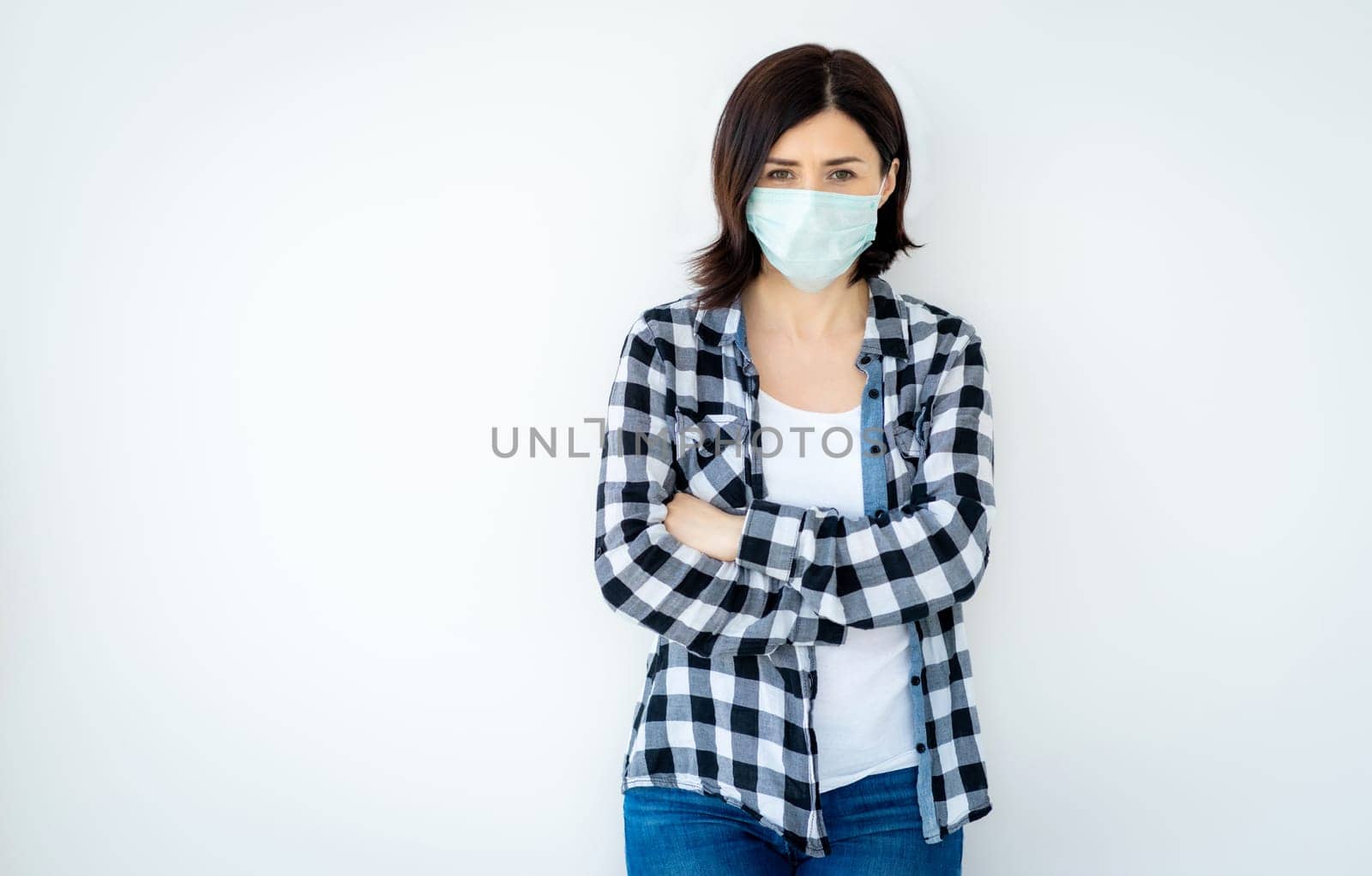 Beautiful woman wearing medical mask isolated on white background