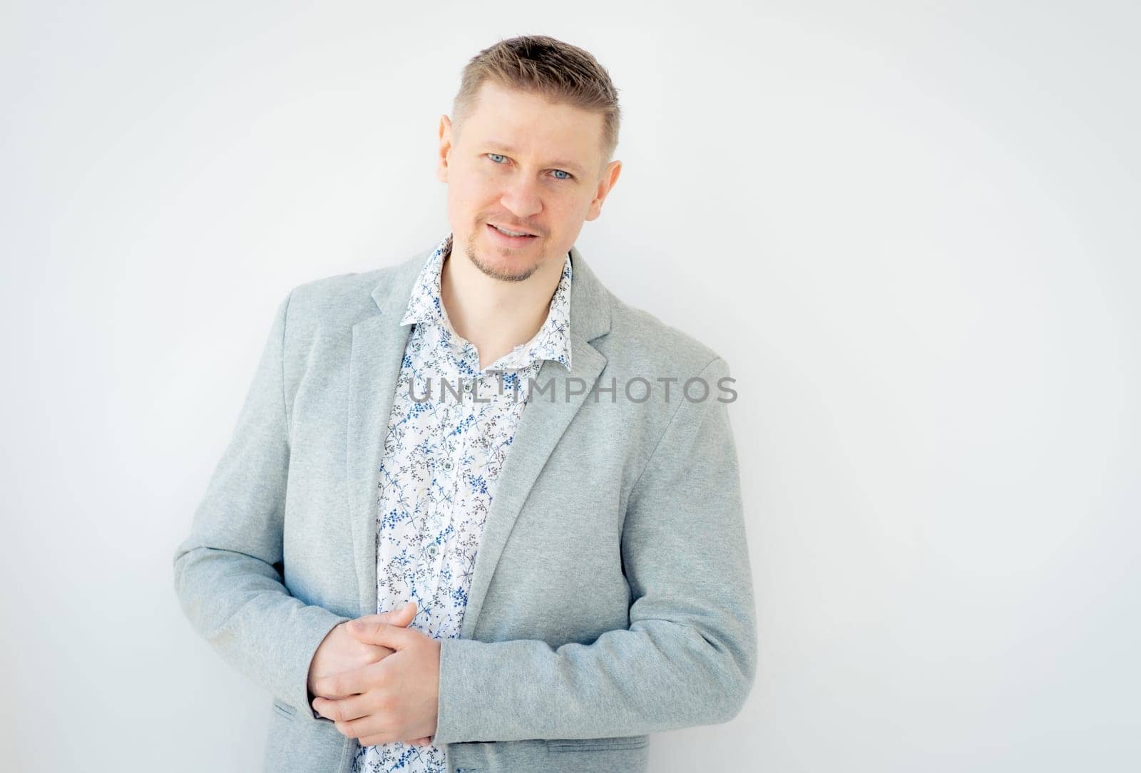 Beautiful man wearing gray jacket isolated on white background