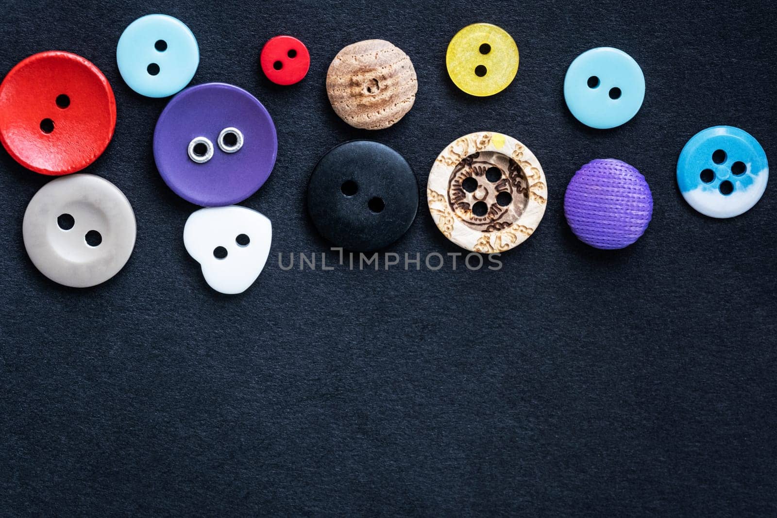 Top view on assortment of sewing buttons with copy space