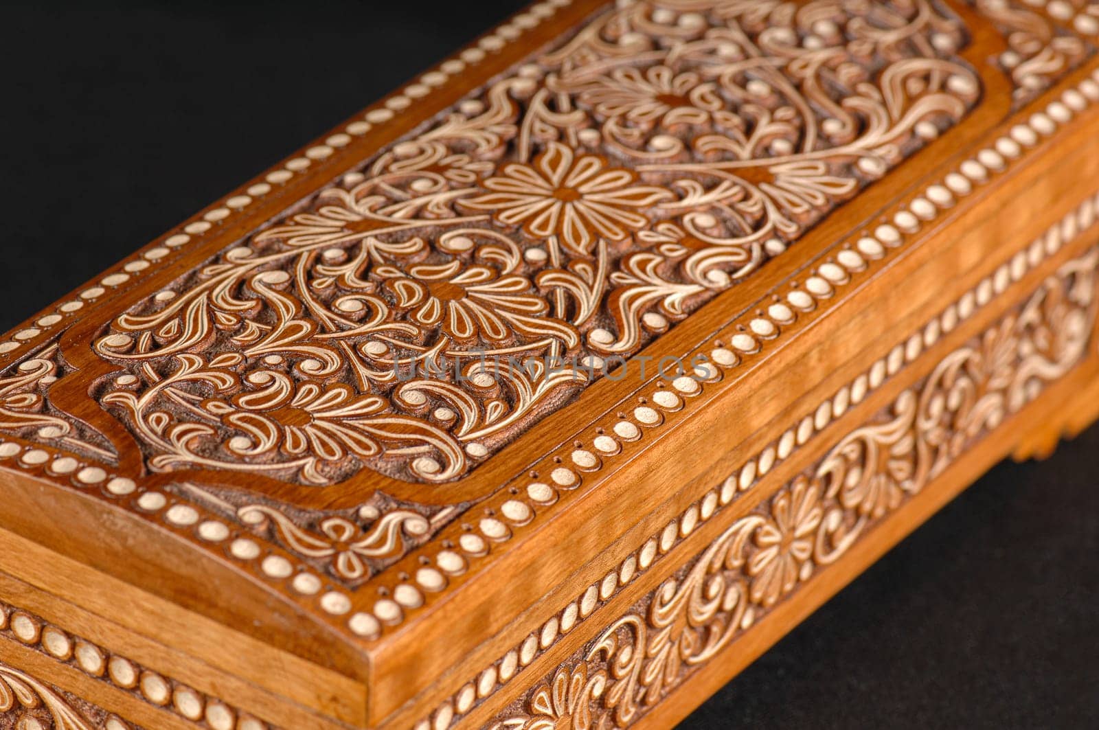 The artistic wood carving on the casket on the black background. Central Asia, Uzbekistan, close-up by A_Karim