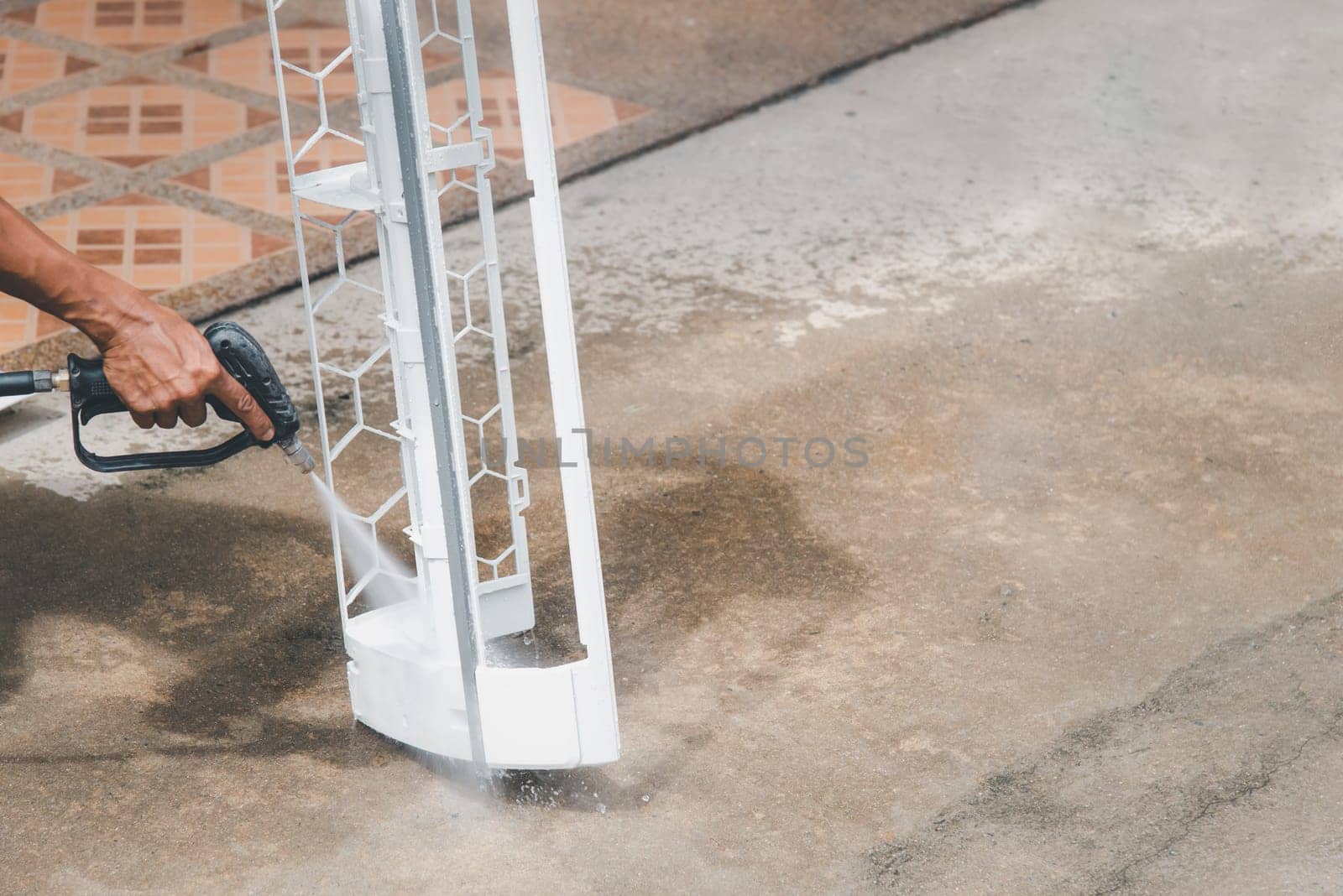 Worker to cleaning coil cooler of air conditioner by water for clean a dust on the wall in customer home when maintenance service