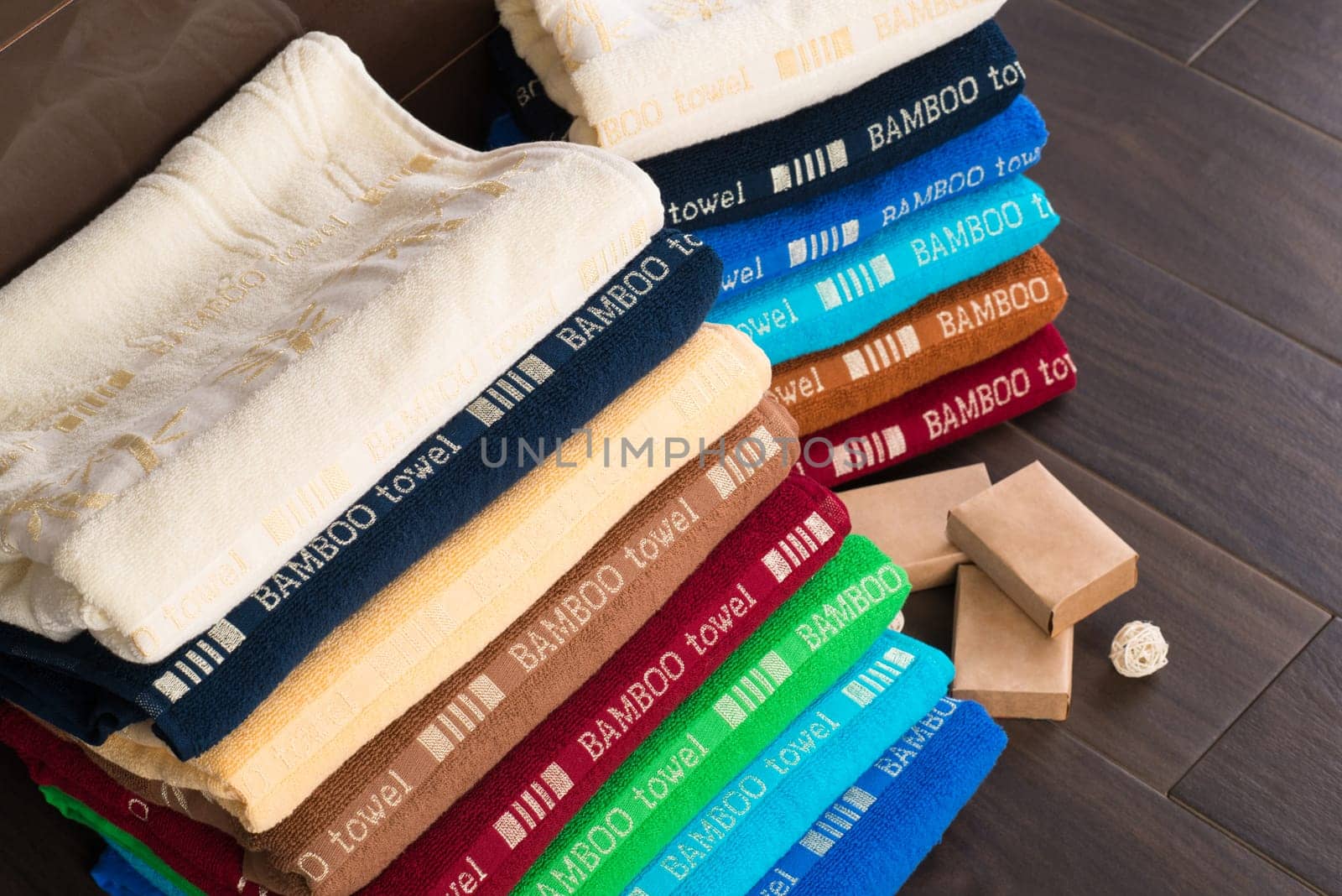 A closeup shot of heaps of folded colorful bamboo towels in a bathroom by A_Karim