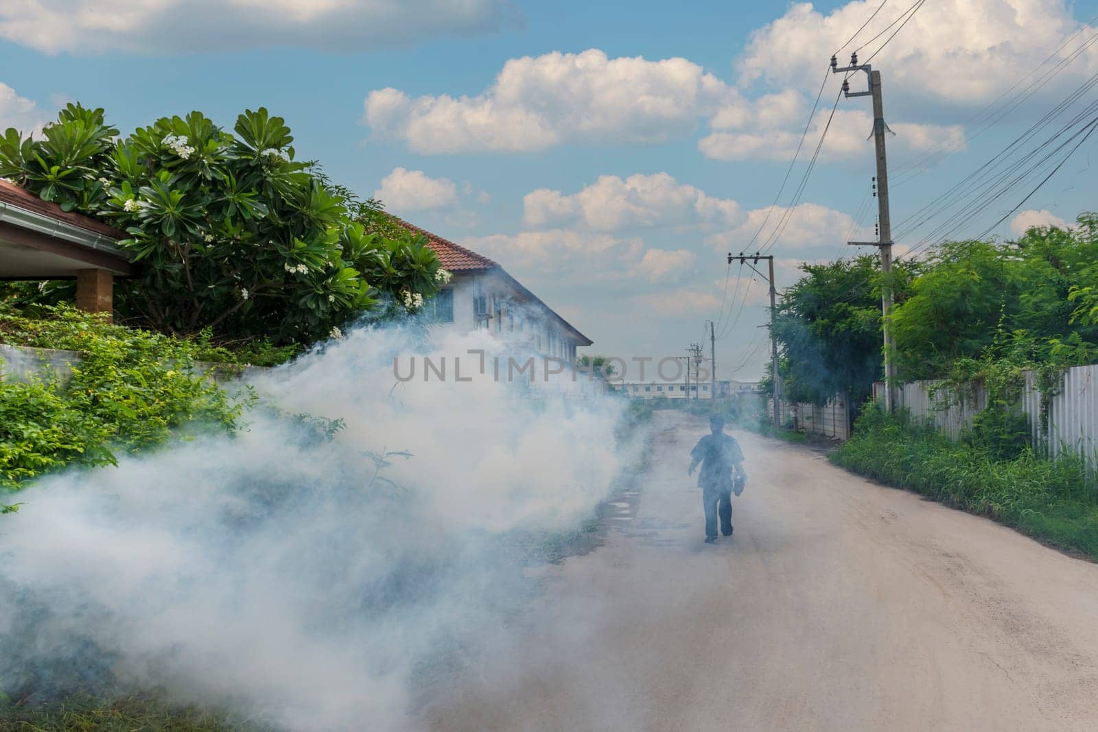 Unidentified people fogging DDT spray for mosquito kill and protect by control mosquito is a carrier of Malaria, Encephalitis, Dengue and Zika virus in village.