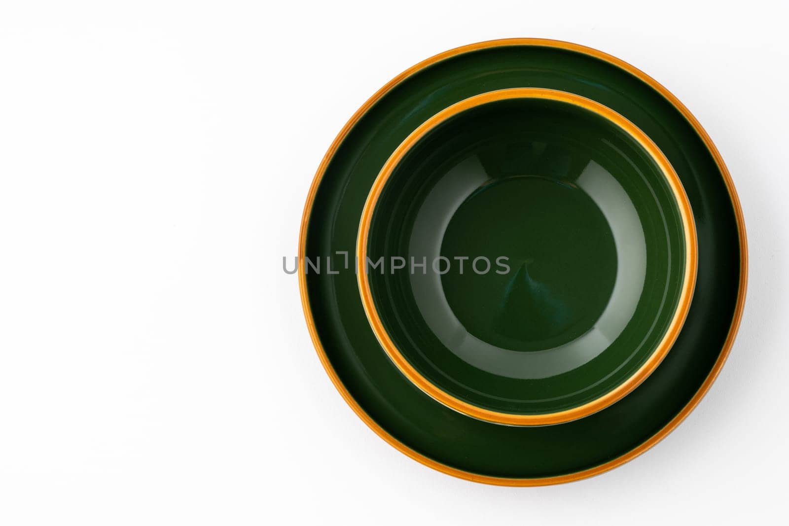 A set of dark green ceramic tableware with orange outlines on a white background by A_Karim