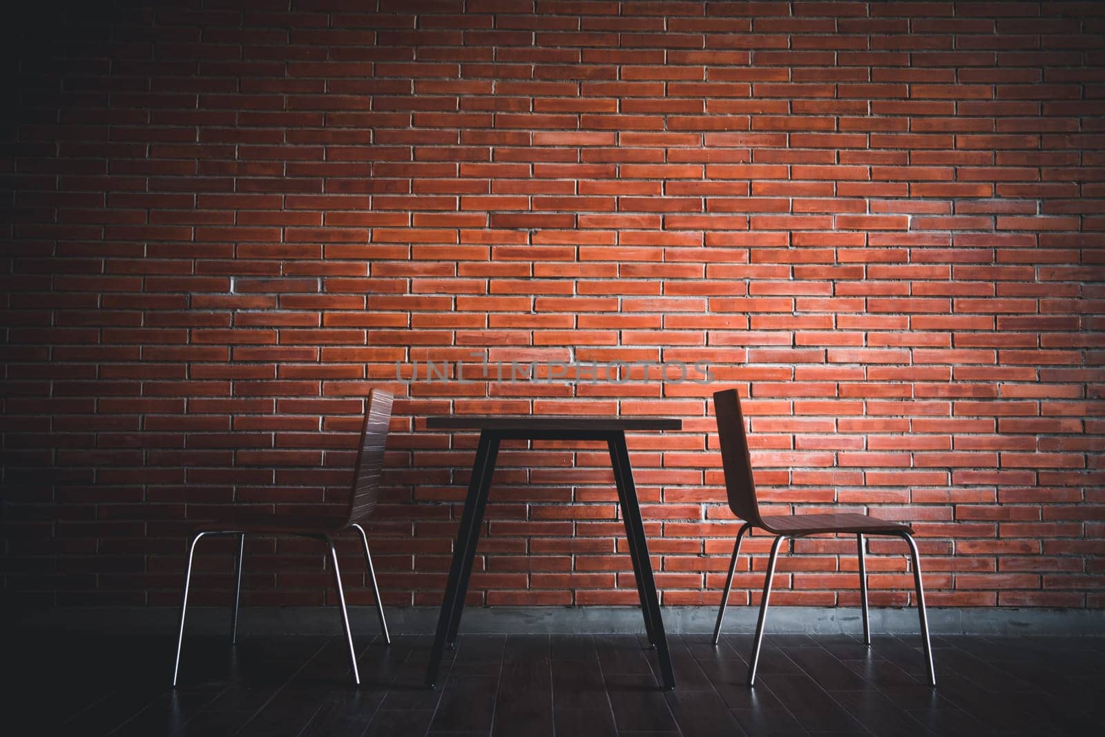 Balcony with red brick wall and table chairs set by PongMoji