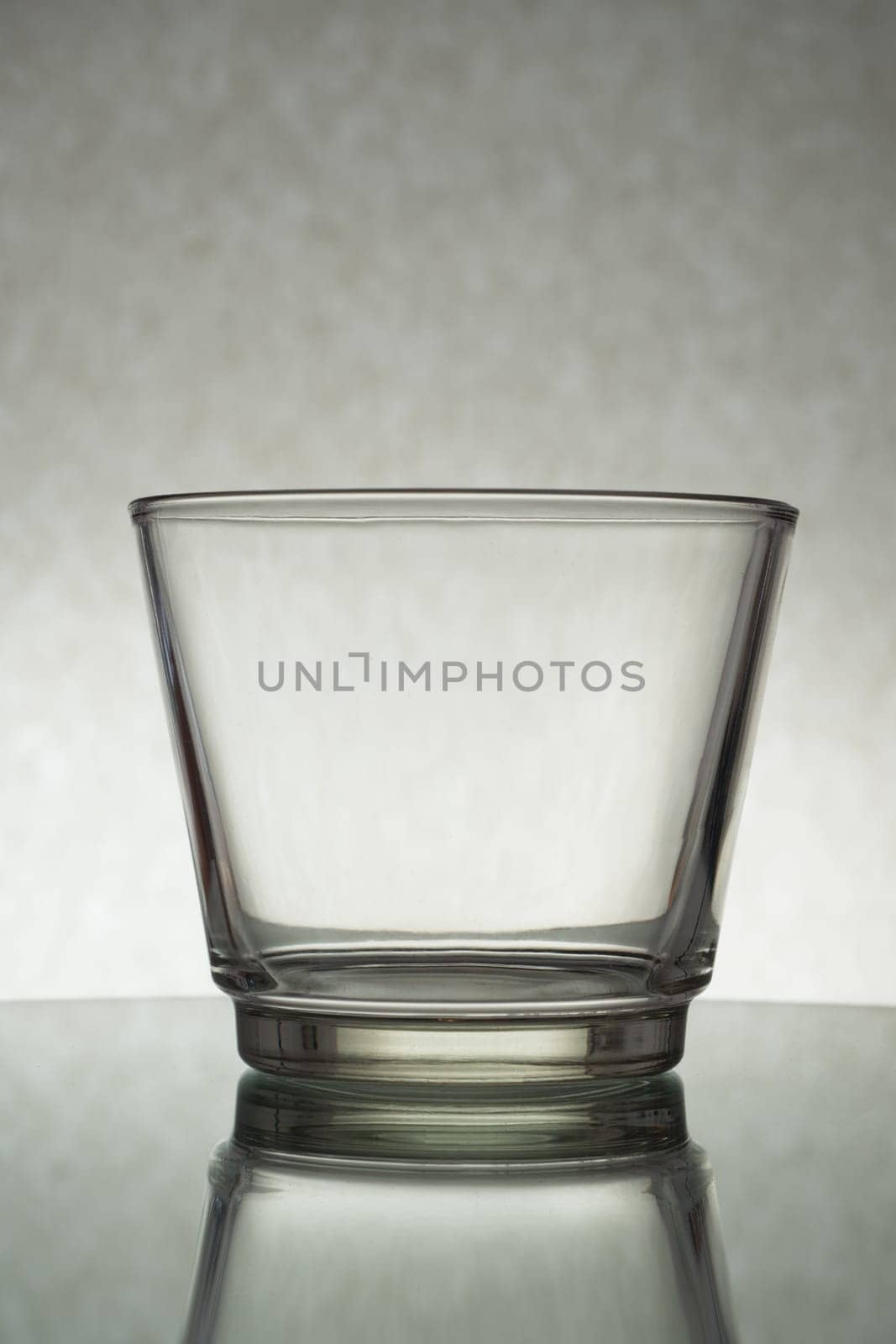 A vertical shot of an empty glass on a grey background by A_Karim