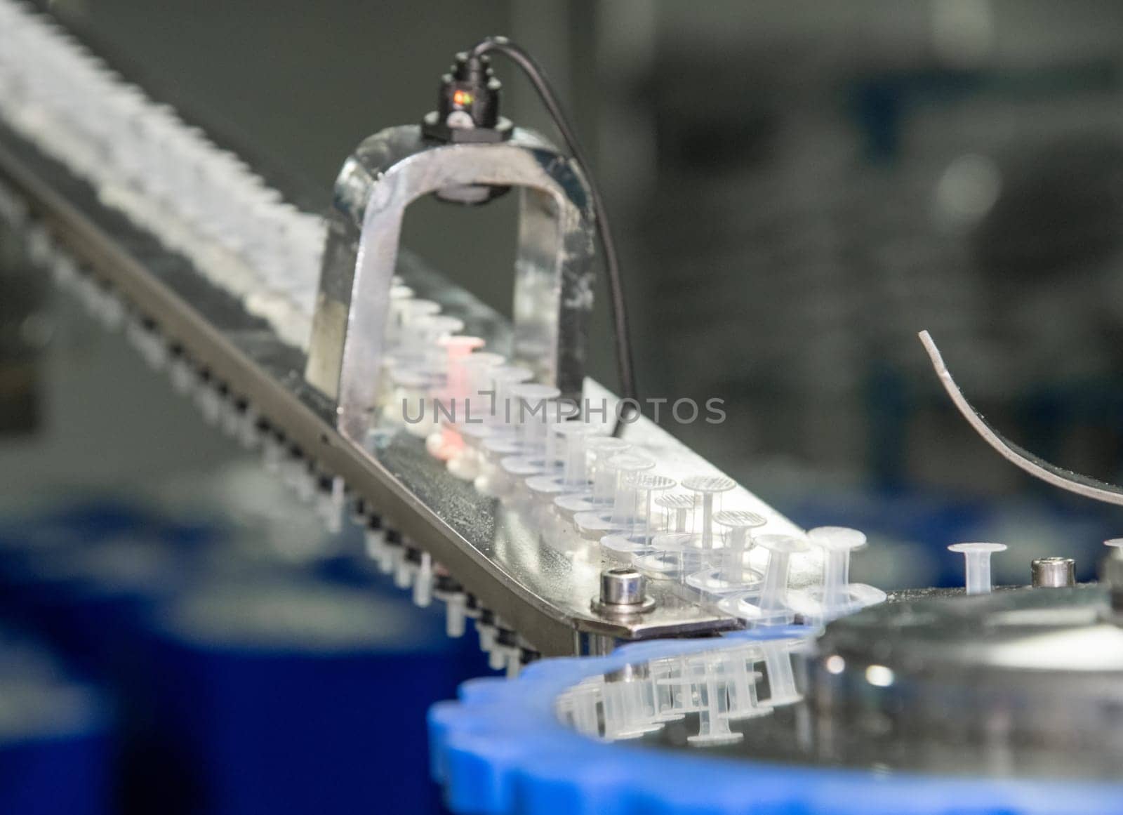 A closeup of the production of medical syringes by A_Karim